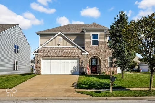 Brick and siding exterior with an arched entryway