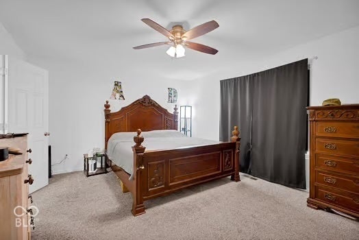 Wall-to-wall carpeting and a ceiling fan with integrated lighting