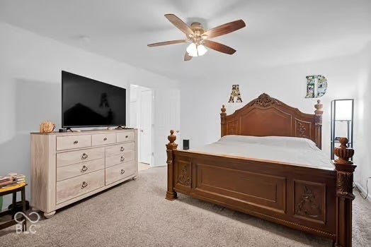 White walls with gray carpet flooring and a ceiling fan