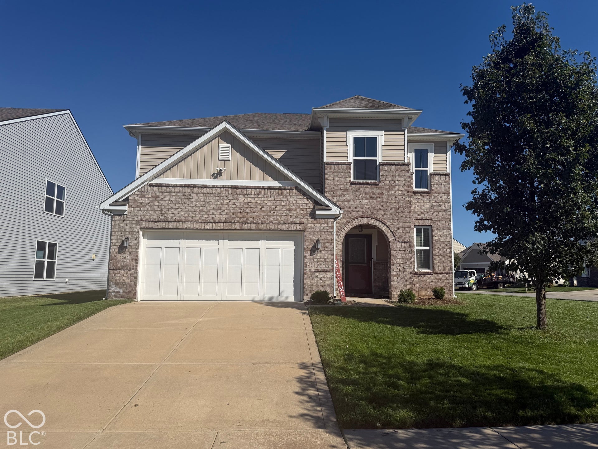 Brick and siding exterior with an arched entryway
