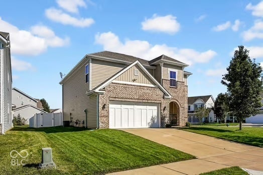 Two-story exterior featuring brick and siding finishes, an attached two-car garage, a covered entry, and a concrete driveway