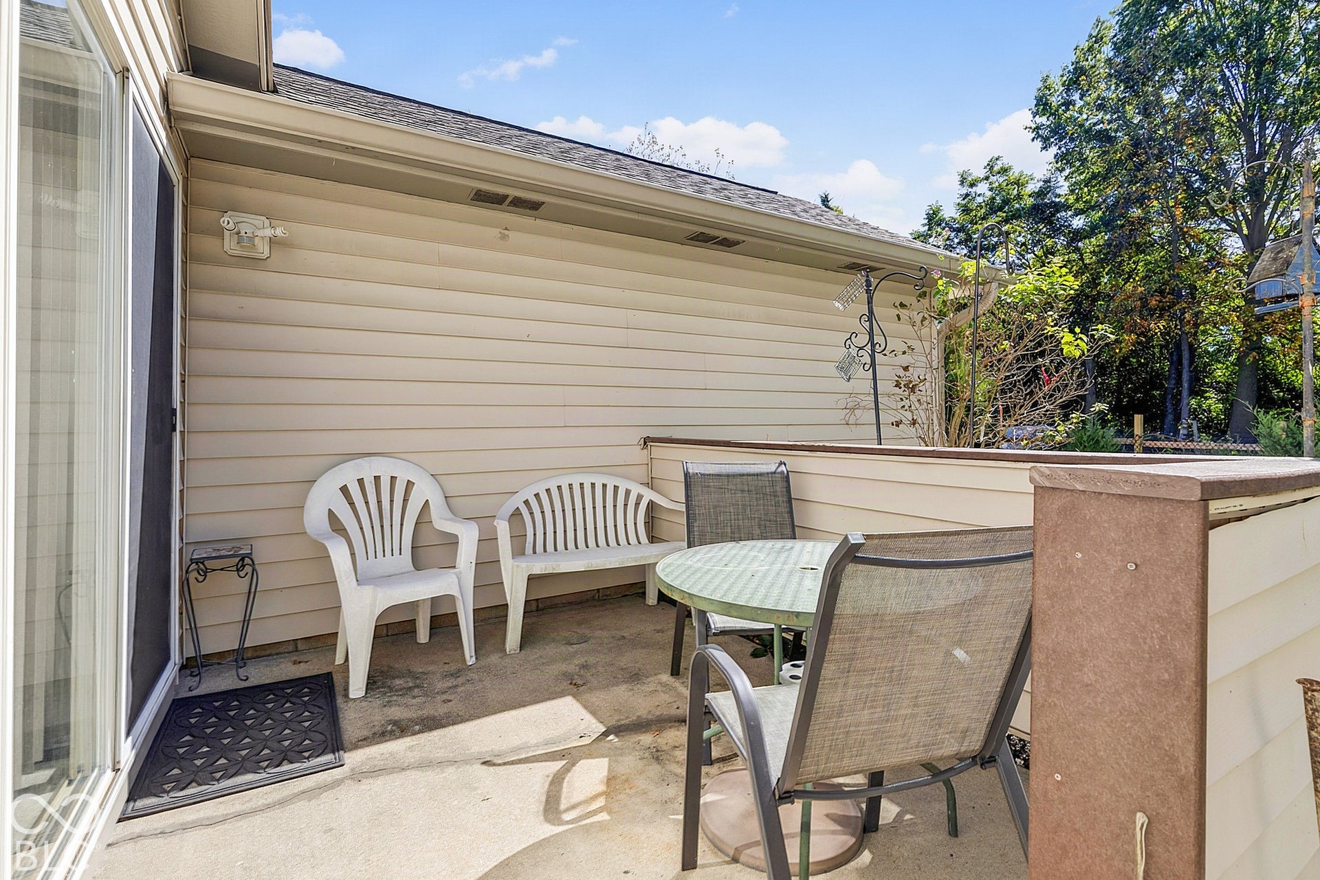 Patio featuring concrete surface, siding exterior, and a sliding glass door