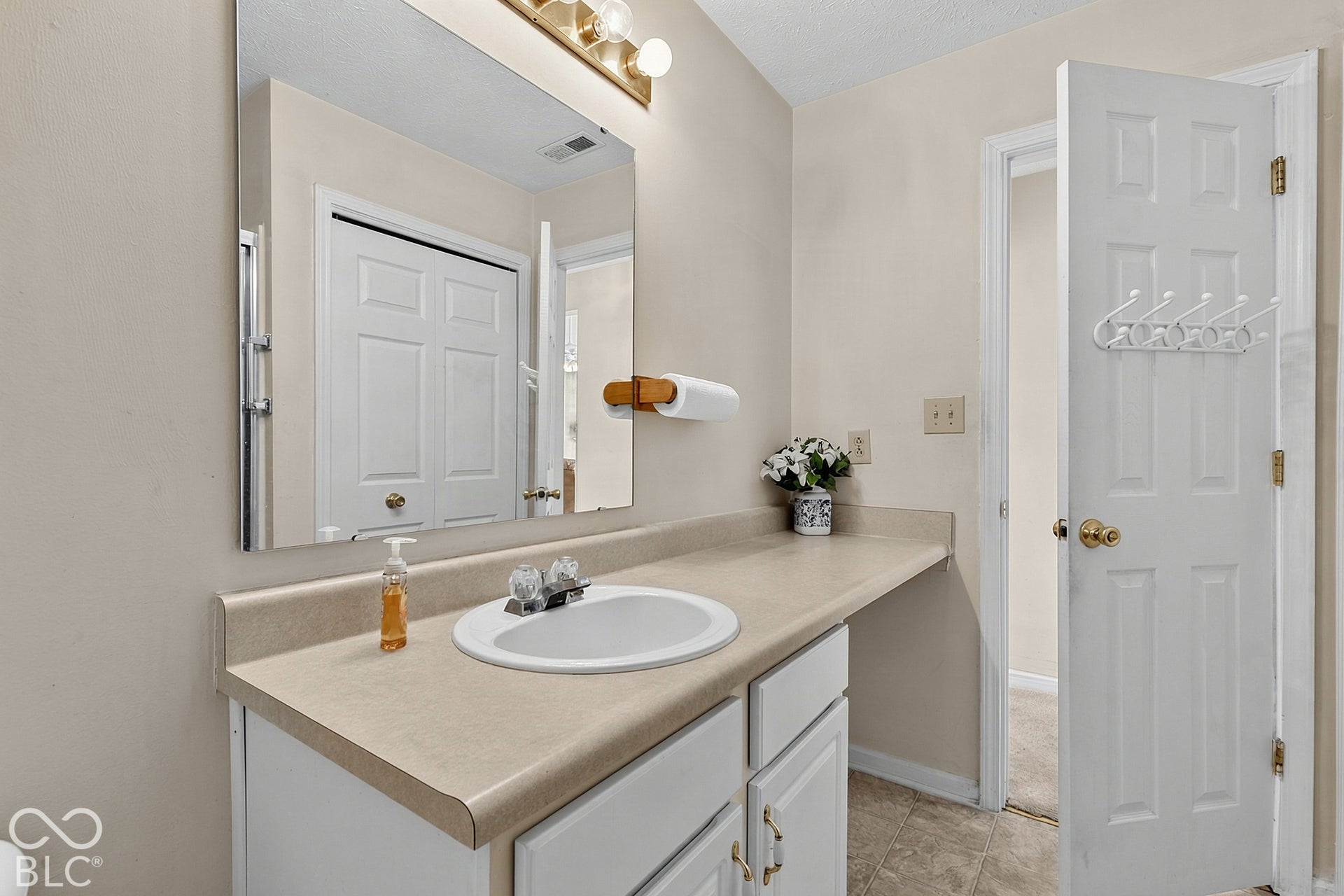 Vanity with integrated sink, dual-handle faucet, and ample countertop space
