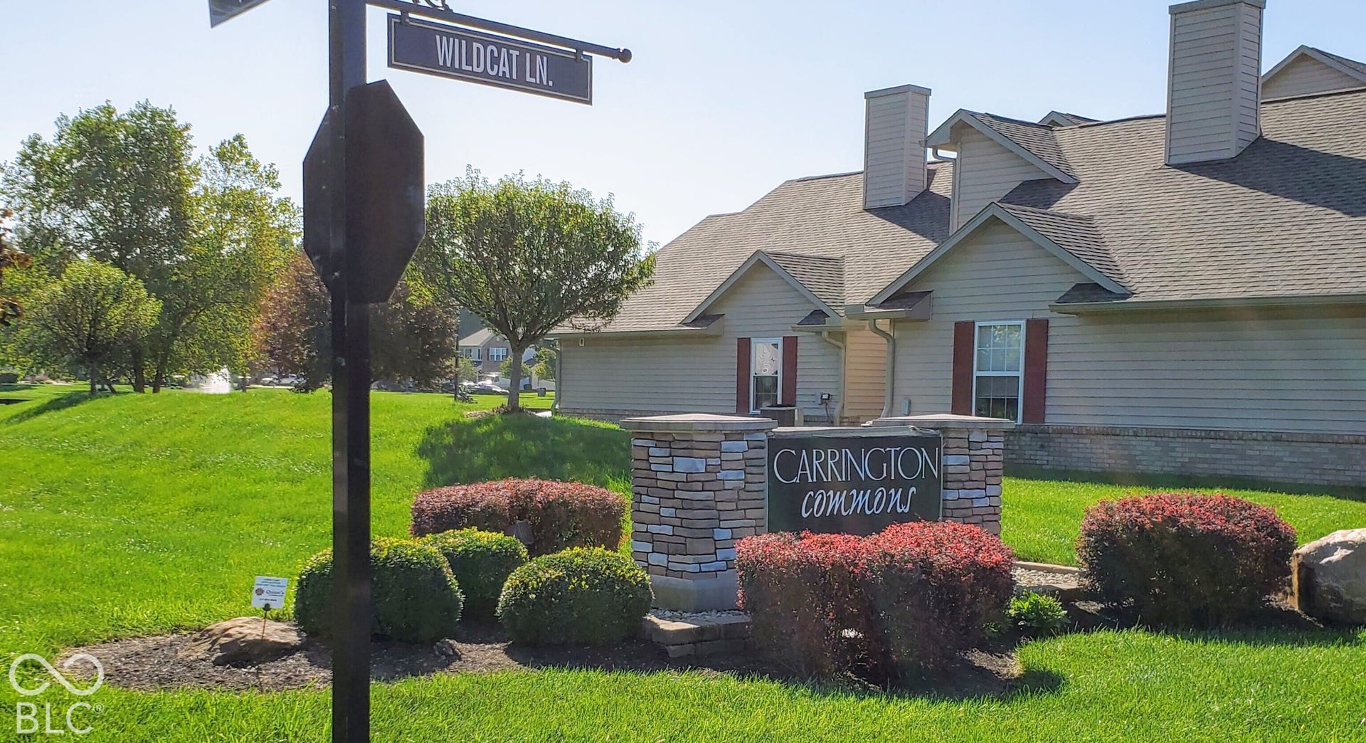 Community entrance sign with stacked stone and landscaping