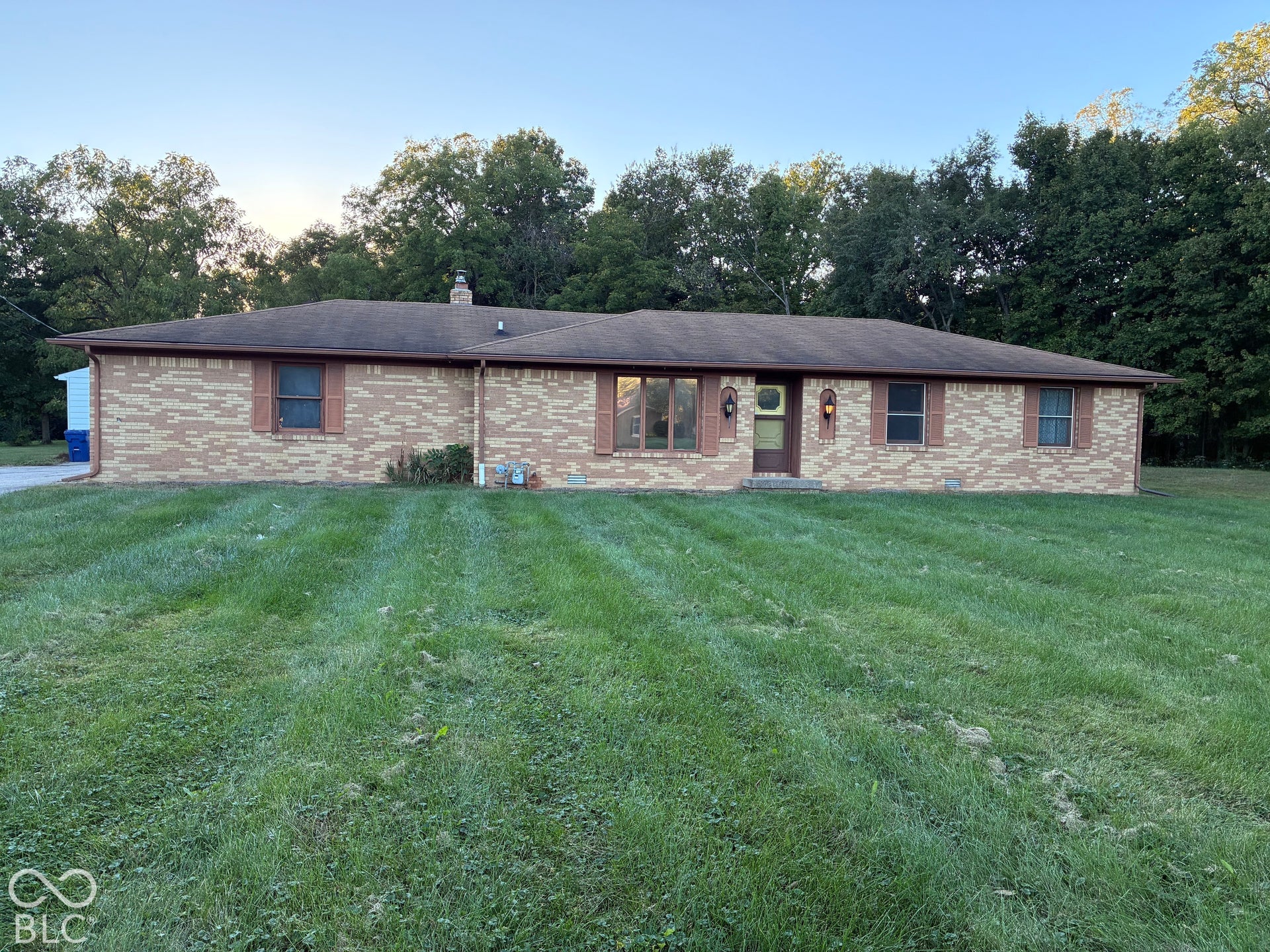 Brick exterior with a brown roof and matching gutters