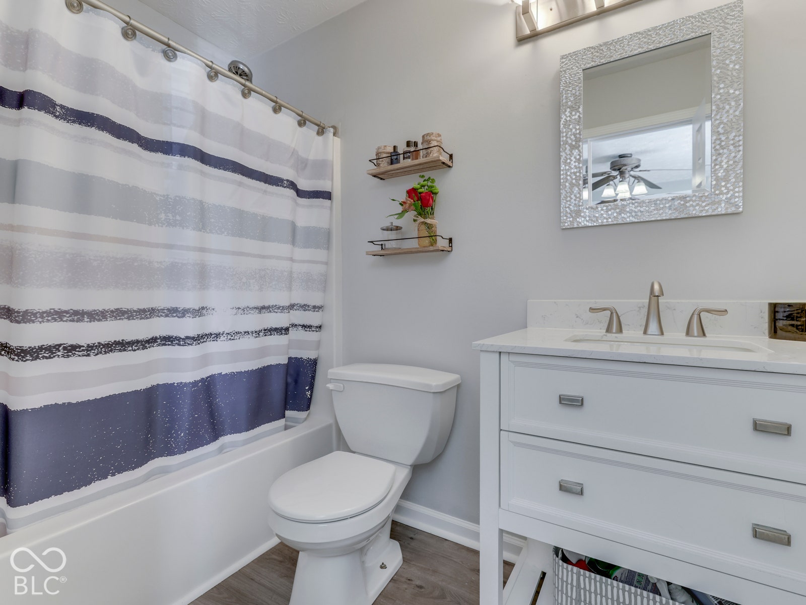 Updated primary bathroom featuring a new vanity and flooring