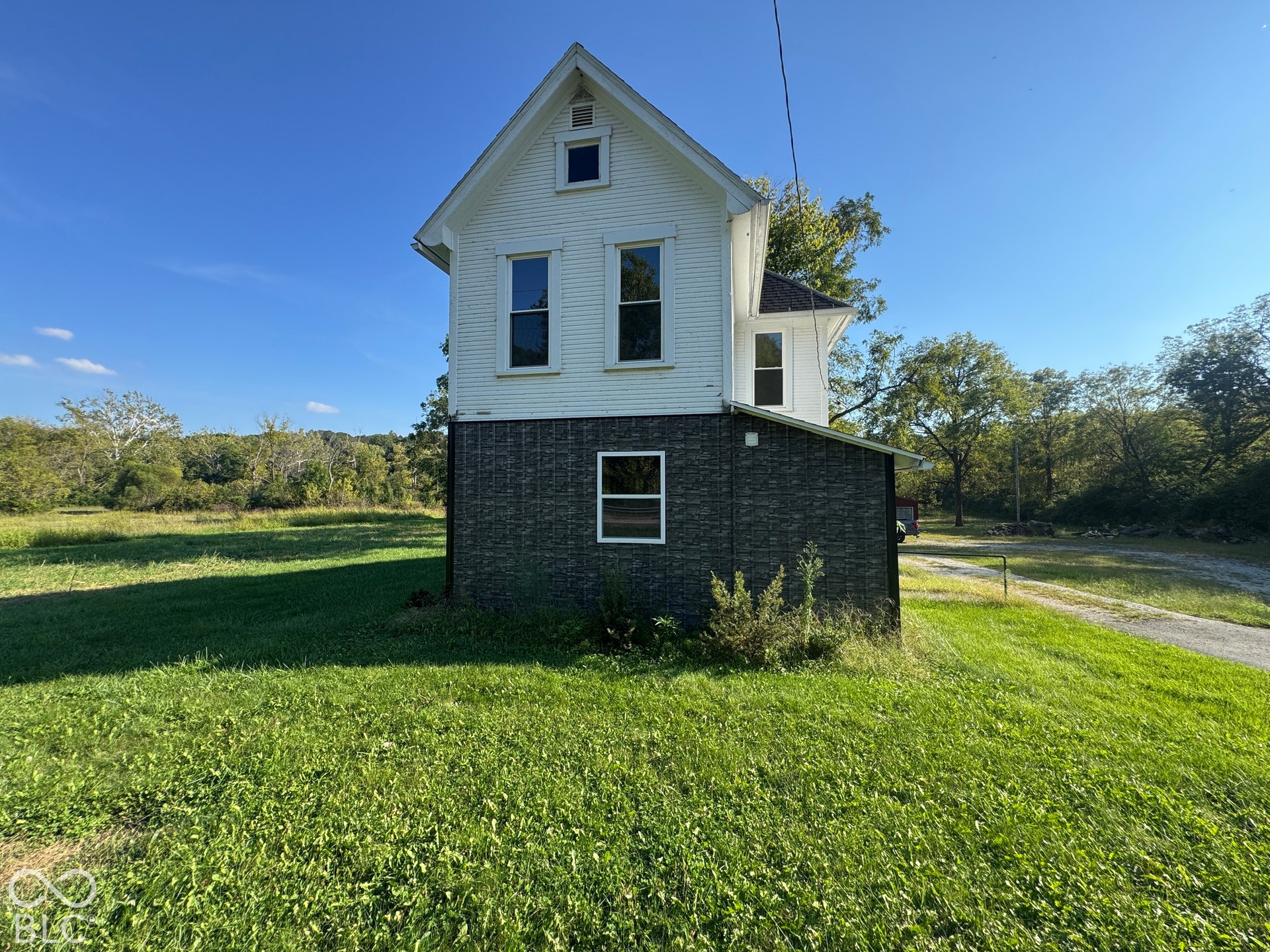 White exterior siding with dark grey lower-level siding