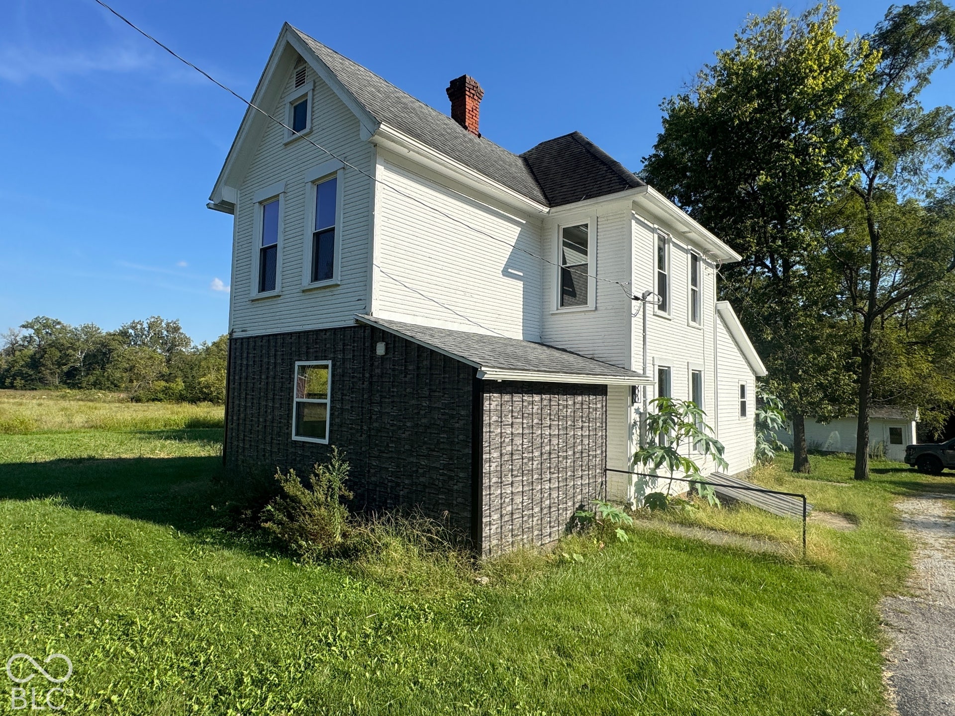 White horizontal siding exterior with dark grey textured lower siding