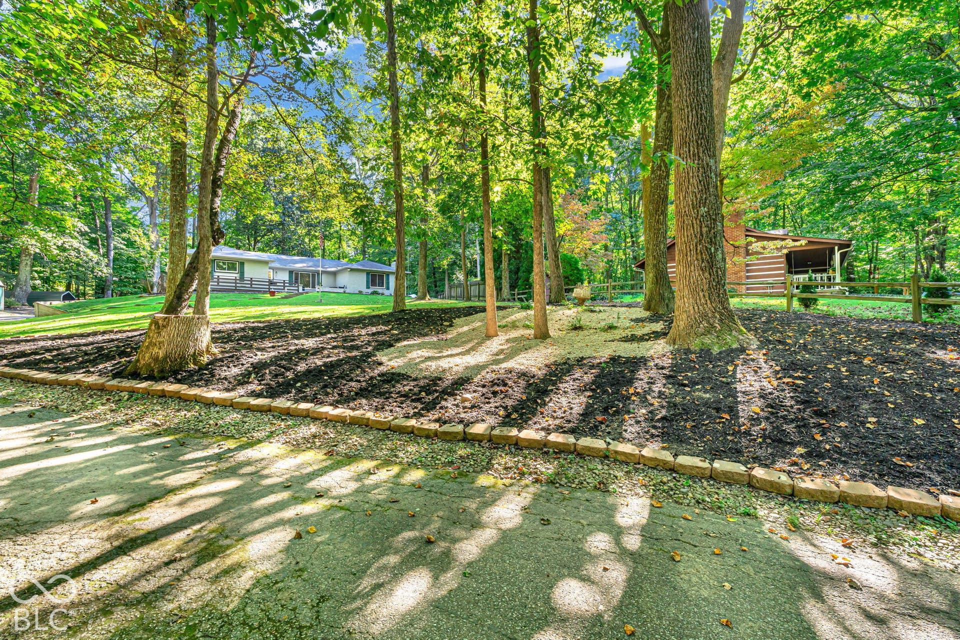 Spacious property featuring mature trees and a log cabin style outbuilding