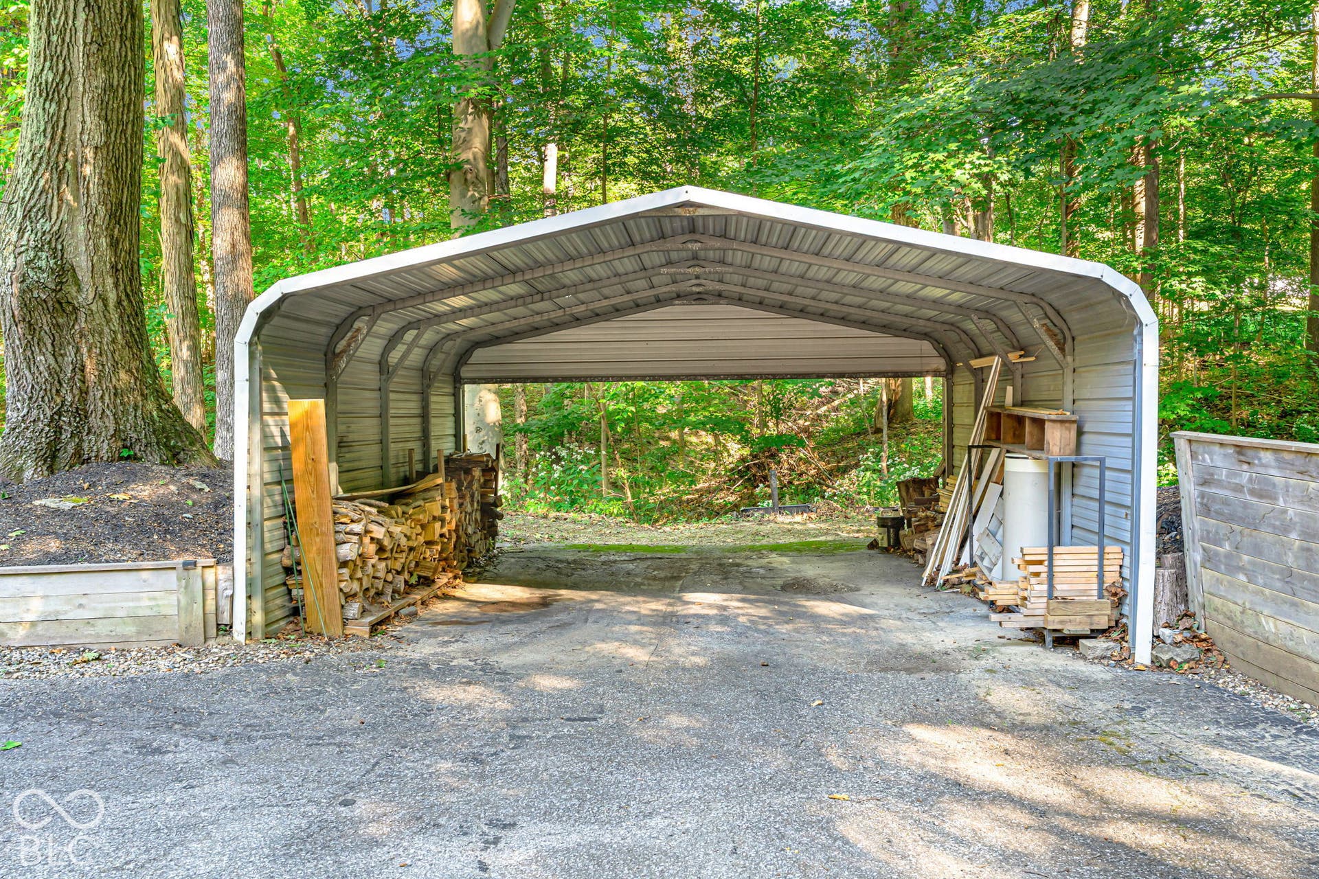 Freestanding metal carport structure providing covered parking