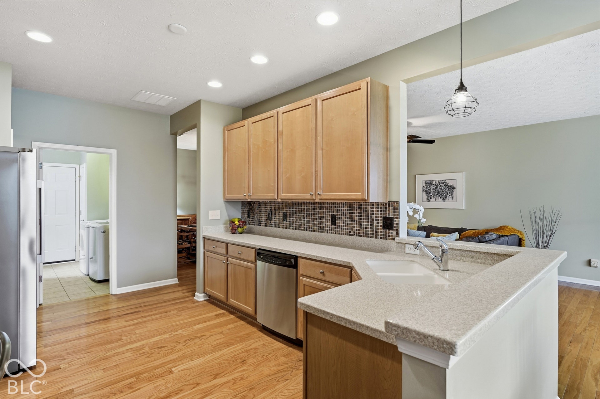 The kitchen with stainless steel applicances.