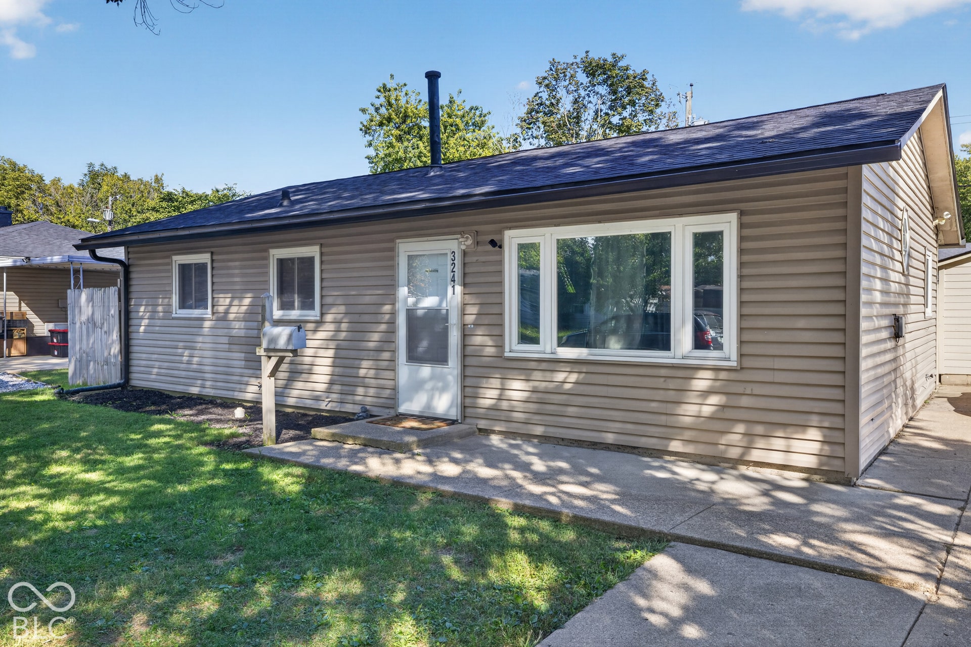 3241 Winton Avenue, Indianapolis, IN 46224 Single-story residence featuring light brown siding and a dark shingle roof