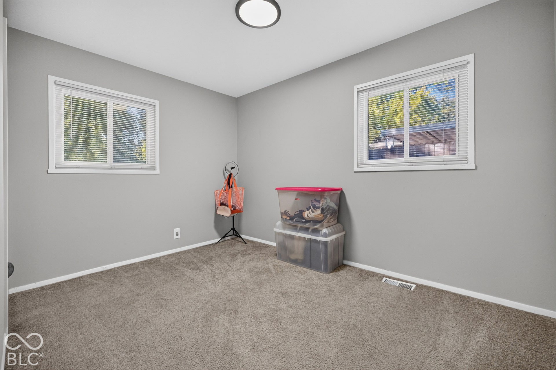 3241 Winton Avenue, Indianapolis, IN 46224 Neutral gray wall paint, two white-framed windows, and a flush-mount ceiling light