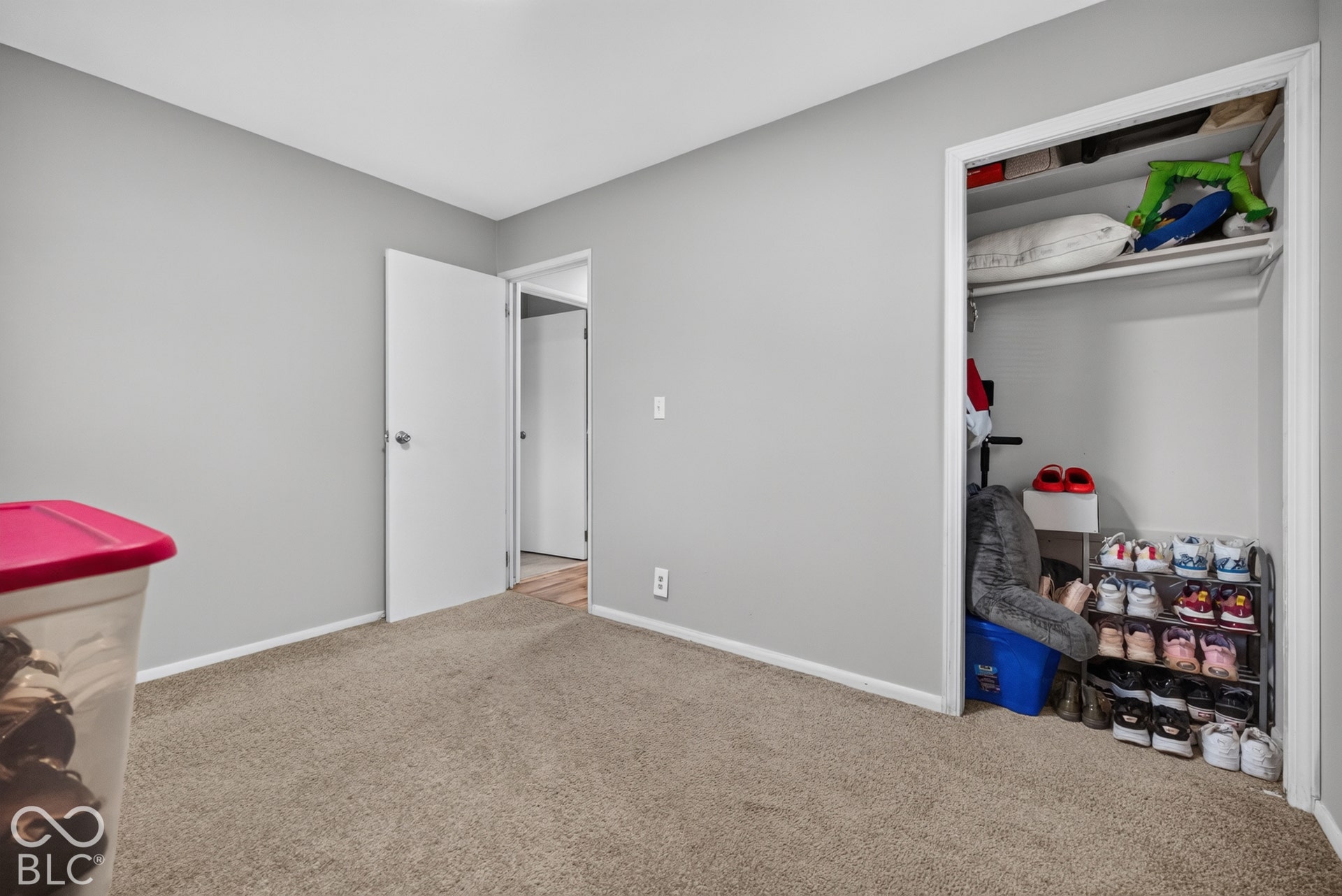 3241 Winton Avenue, Indianapolis, IN 46224 Neutral-toned wall paint with coordinating carpeting and built-in closet storage