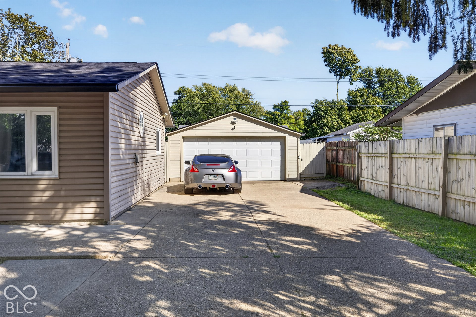 3241 Winton Avenue, Indianapolis, IN 46224 Detached garage with a white overhead door and an exterior light fixture