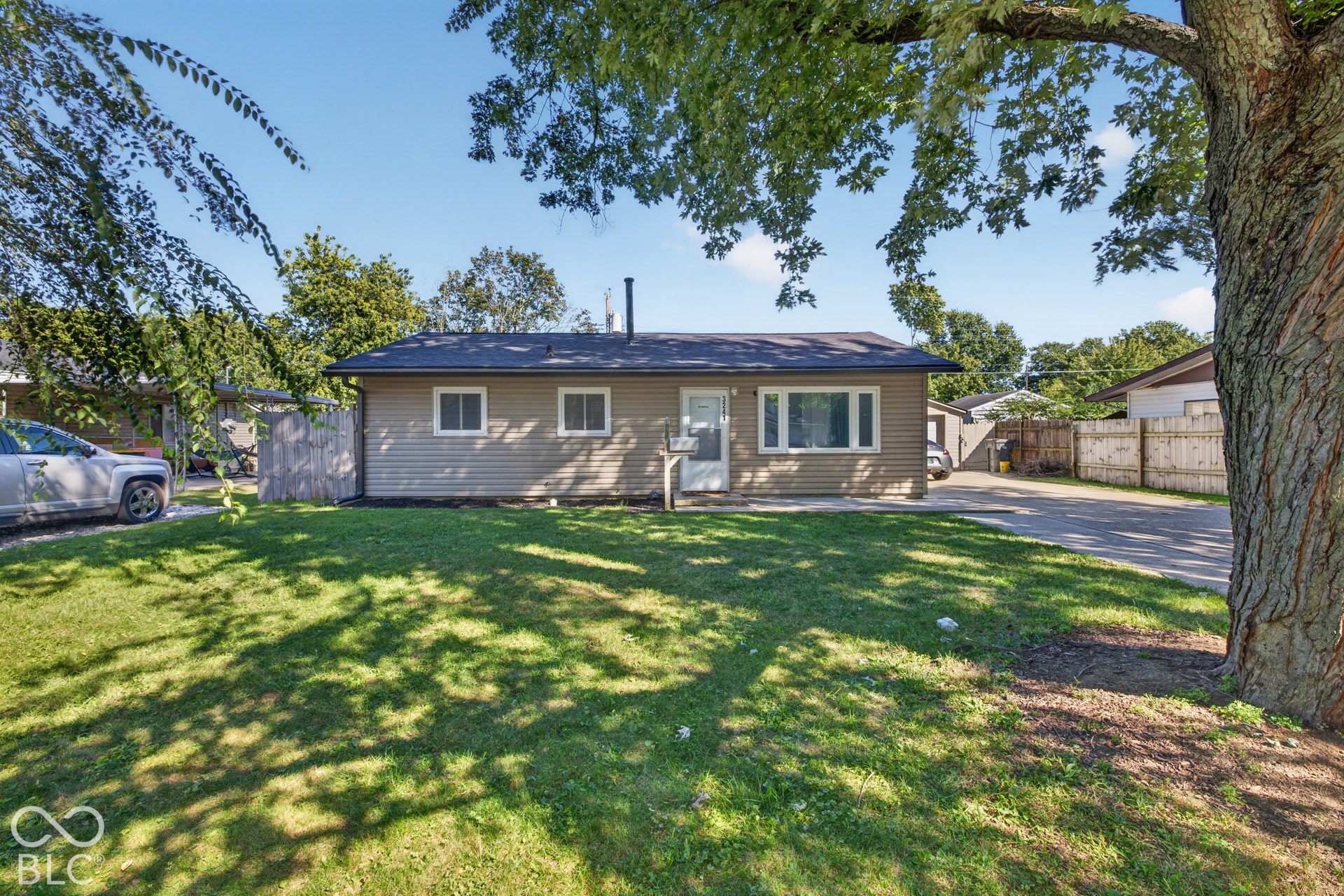 3241 Winton Avenue, Indianapolis, IN 46224 Ranch-style exterior with horizontal siding, multiple windows, and a dark shingle roof