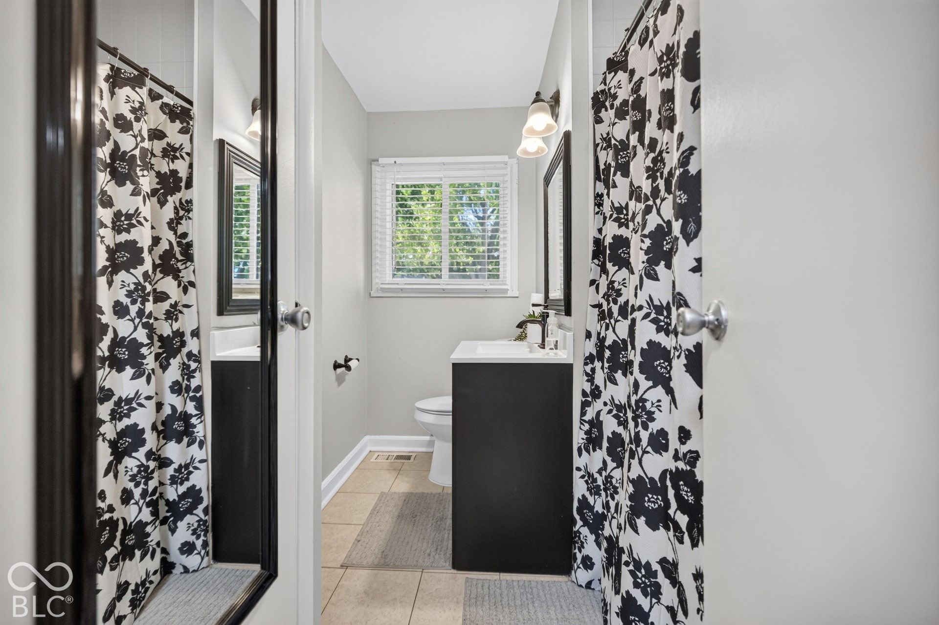 3241 Winton Avenue, Indianapolis, IN 46224 Bathroom featuring a single window, a dark vanity with a white countertop, and tile flooring