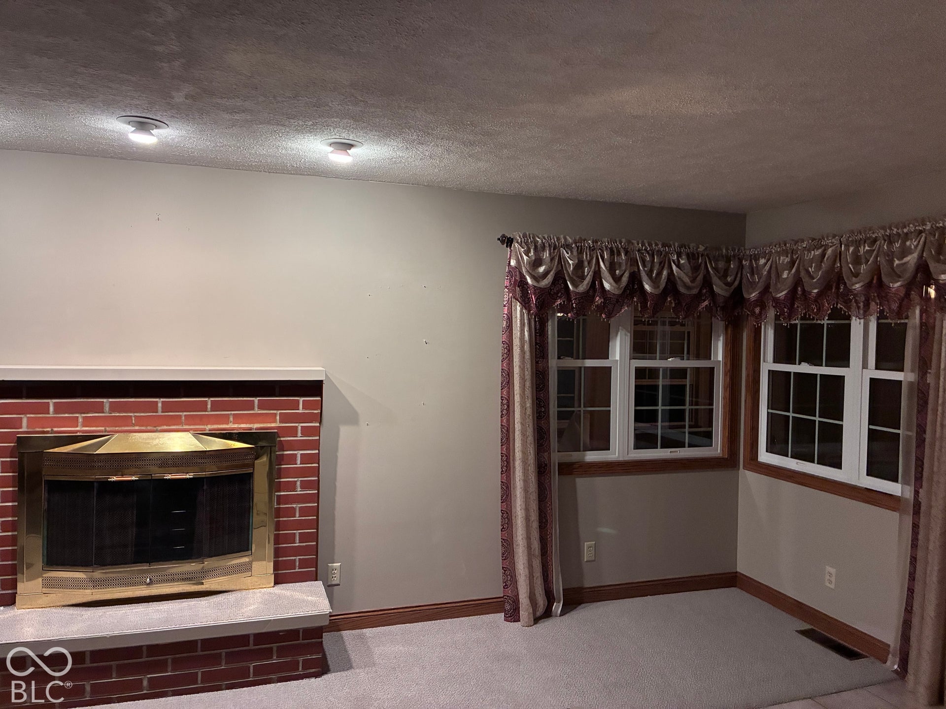 Brick fireplace with a brass firebox