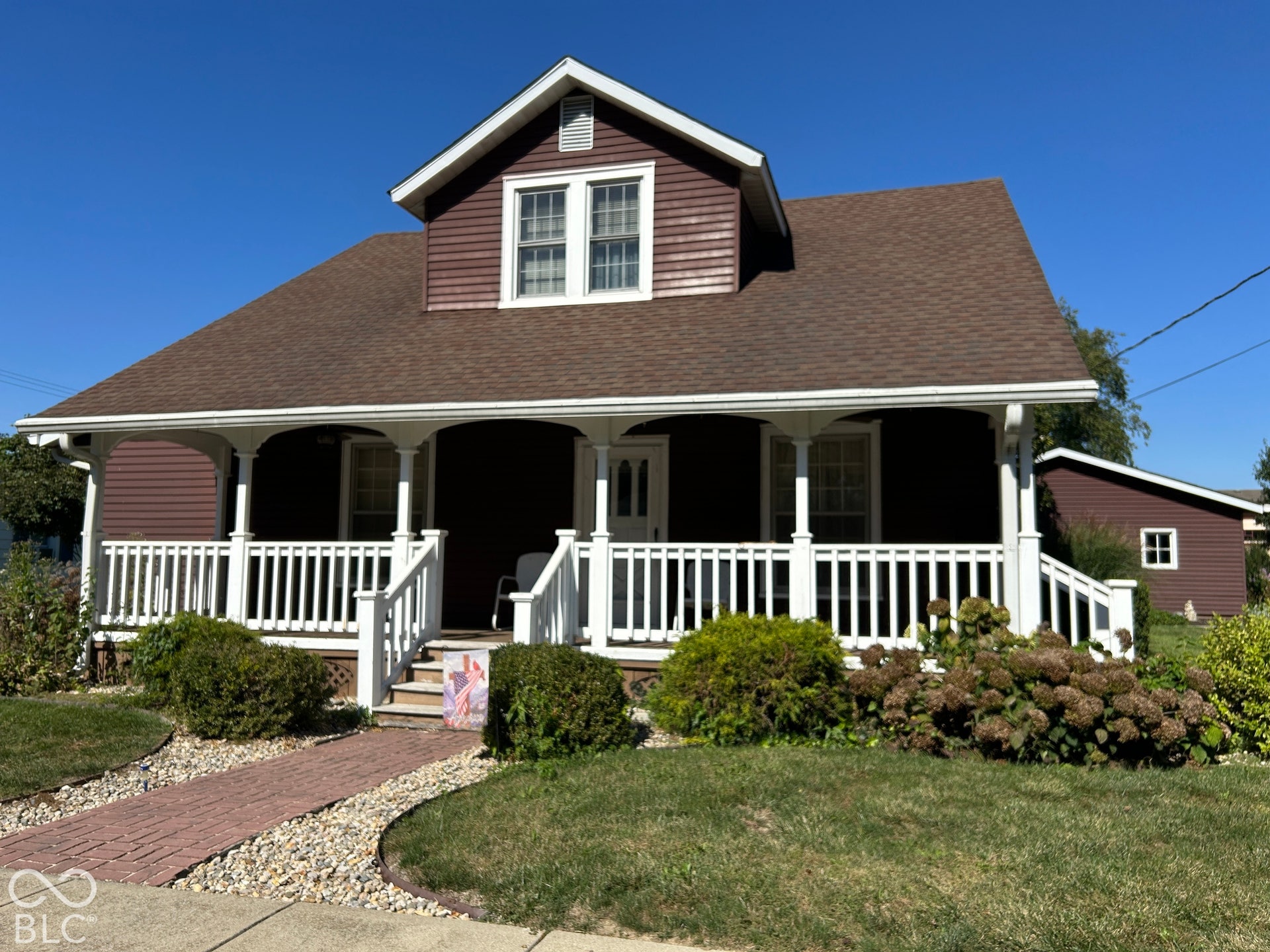 Two-story residence with brown siding and white trim