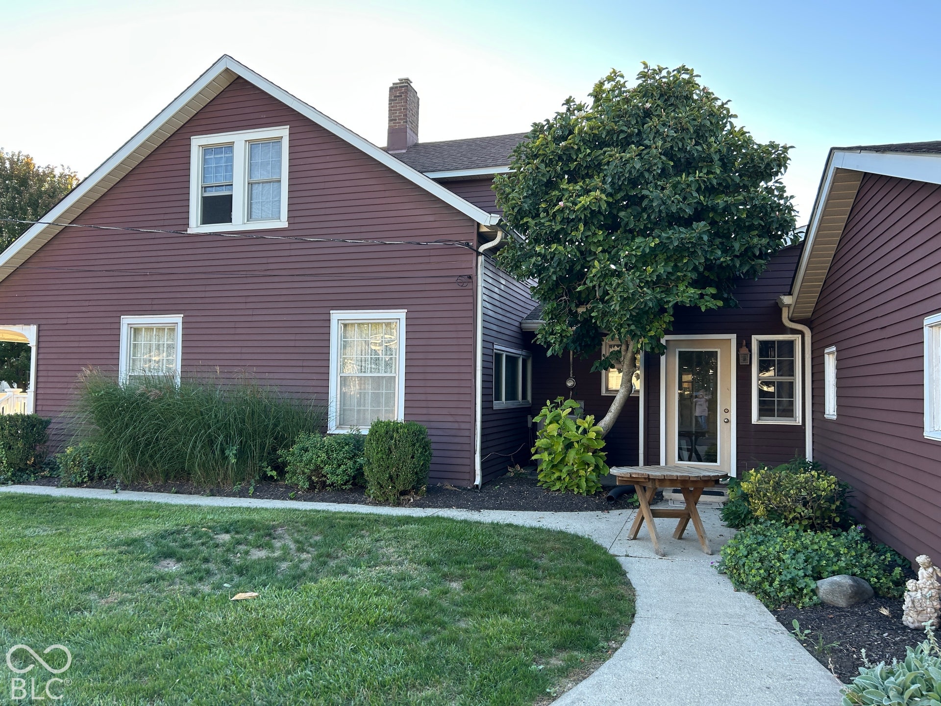 Wood-sided exterior with white trim and a gabled roofline