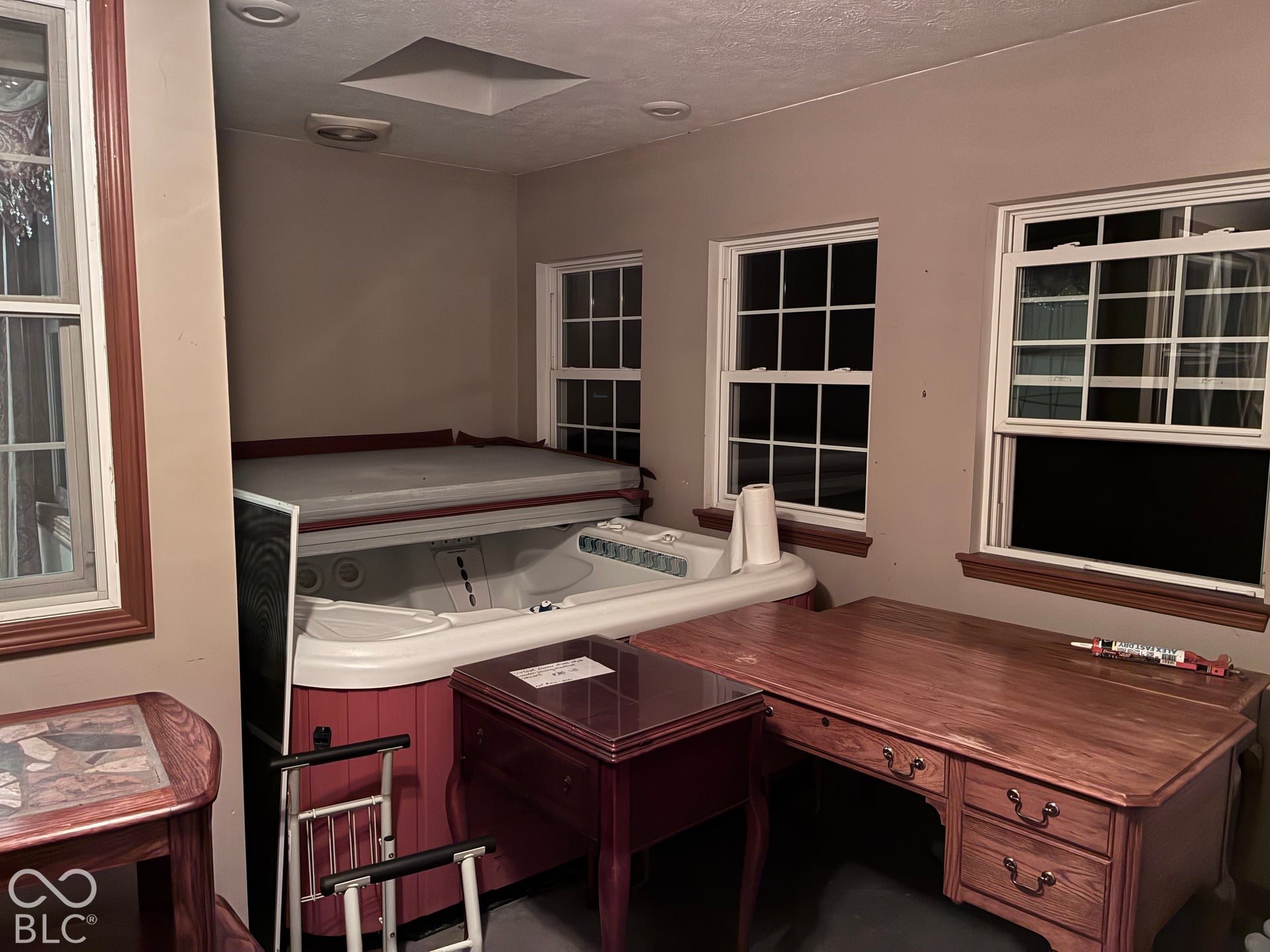 Recessed ceiling lighting, ceiling skylight, multiple paneled windows, and a built-in spa