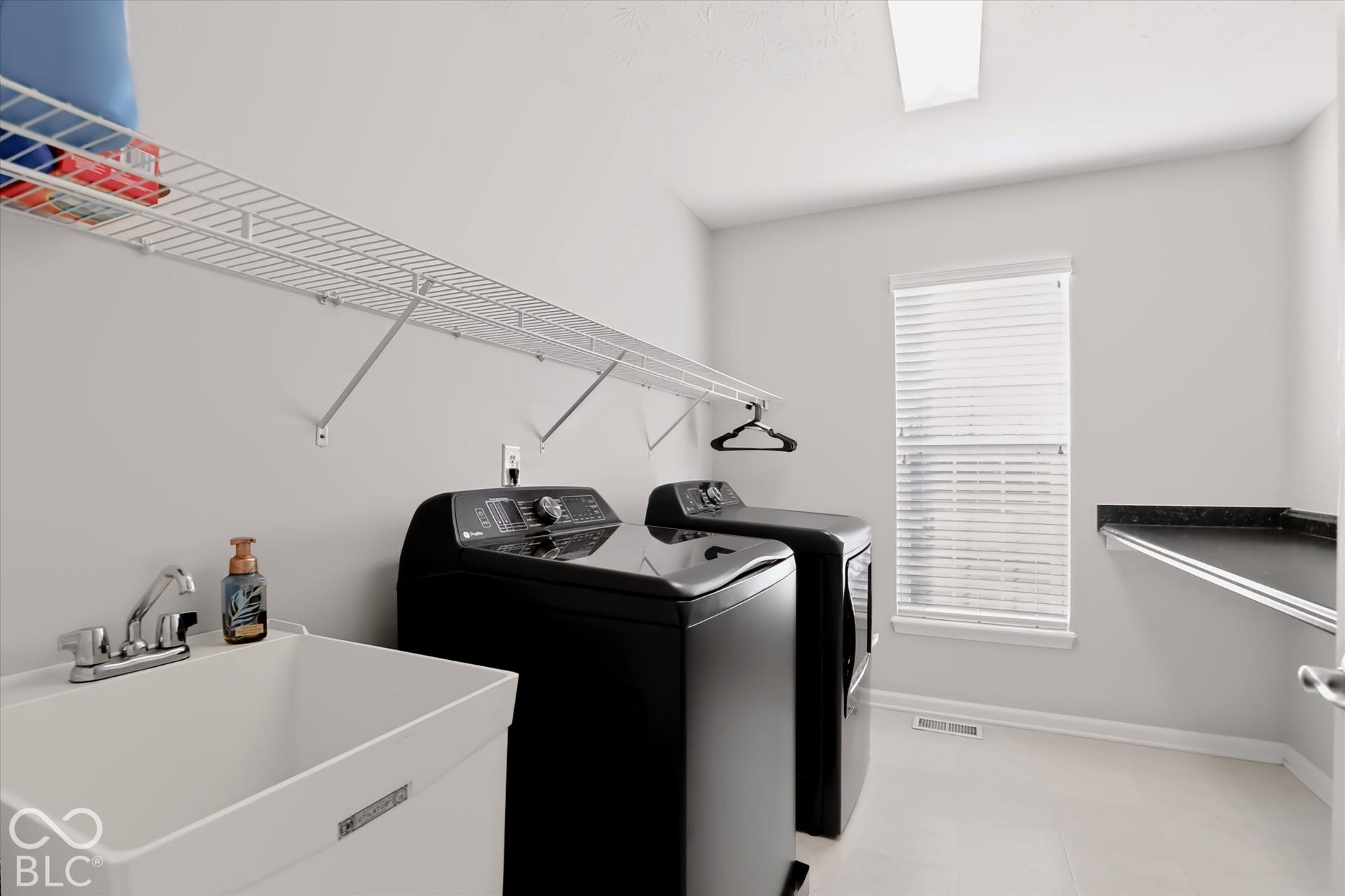 2nd Floor Laundry w/ large folding countertop + utility sink. CONVENIENT!