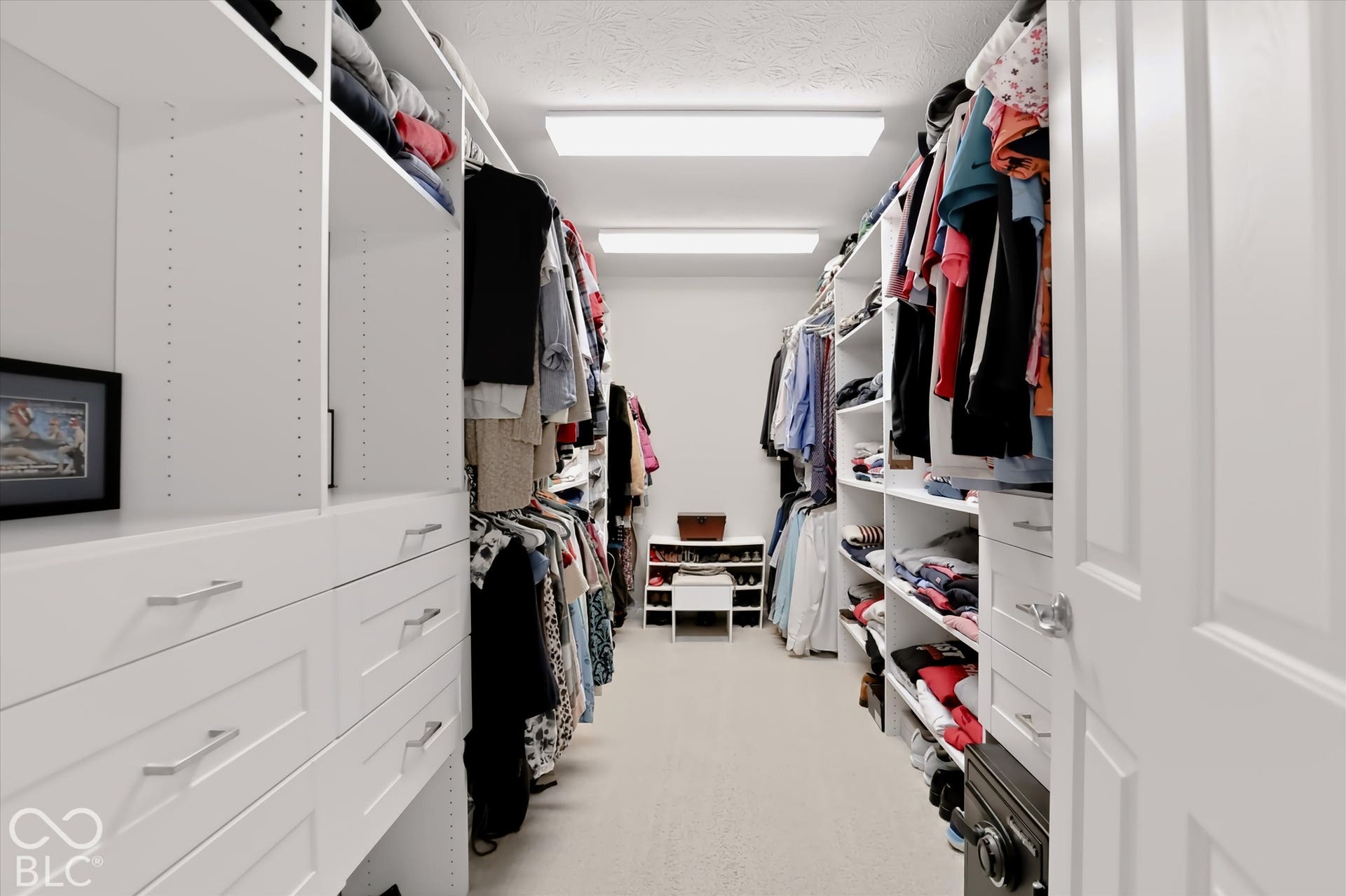 Primary Bedroom - Large walk in closet with custom shelving