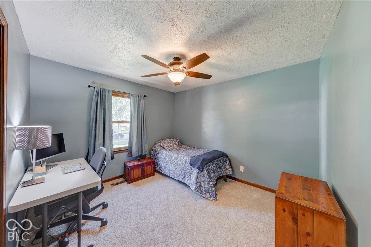 New carpeting, wood-finish trim, and a ceiling fan with integrated lighting