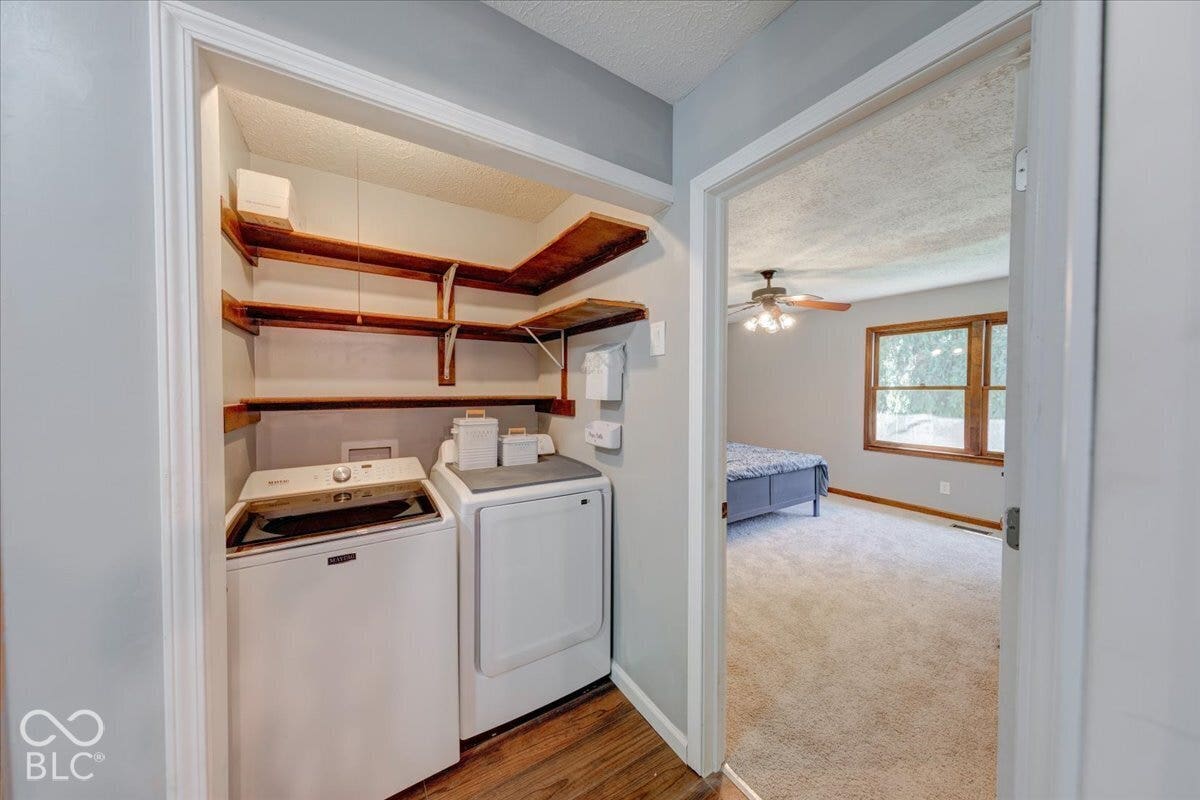 Laundry closet with wood-finish shelving