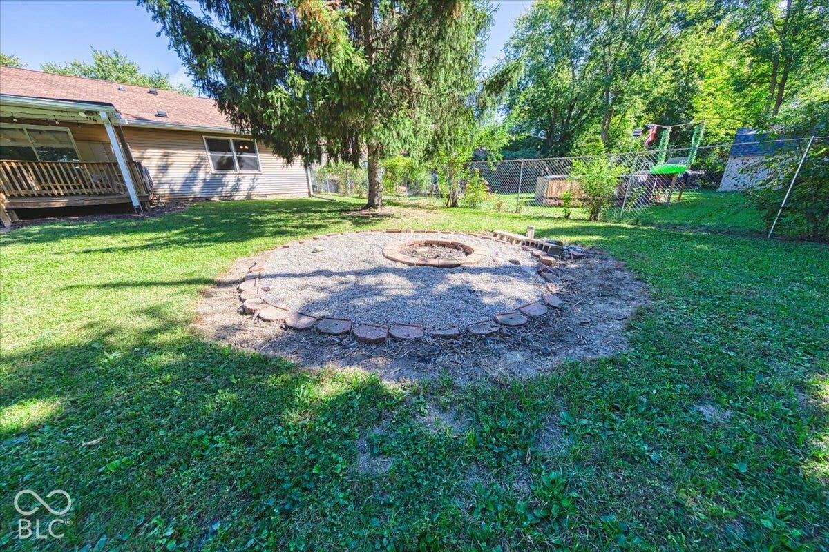 with built-in fire pit with brick edging and pea gravel base