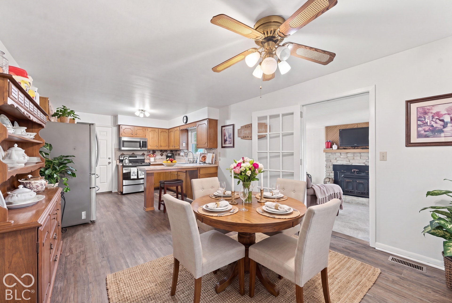 Virtually Altered - Wood-finish flooring, wood cabinetry, and stainless steel appliances