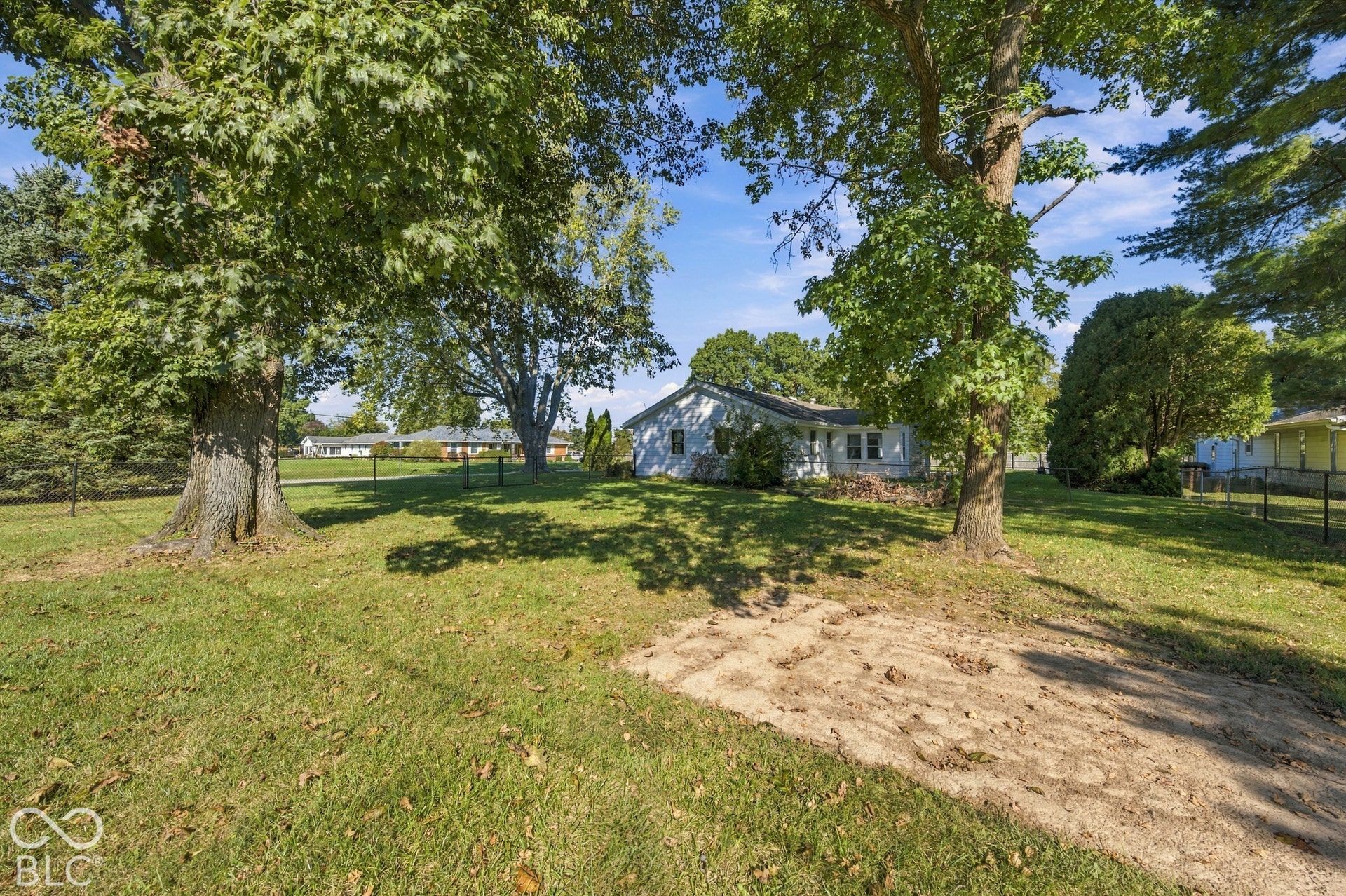 Expansive lot with mature trees and a manicured lawn
