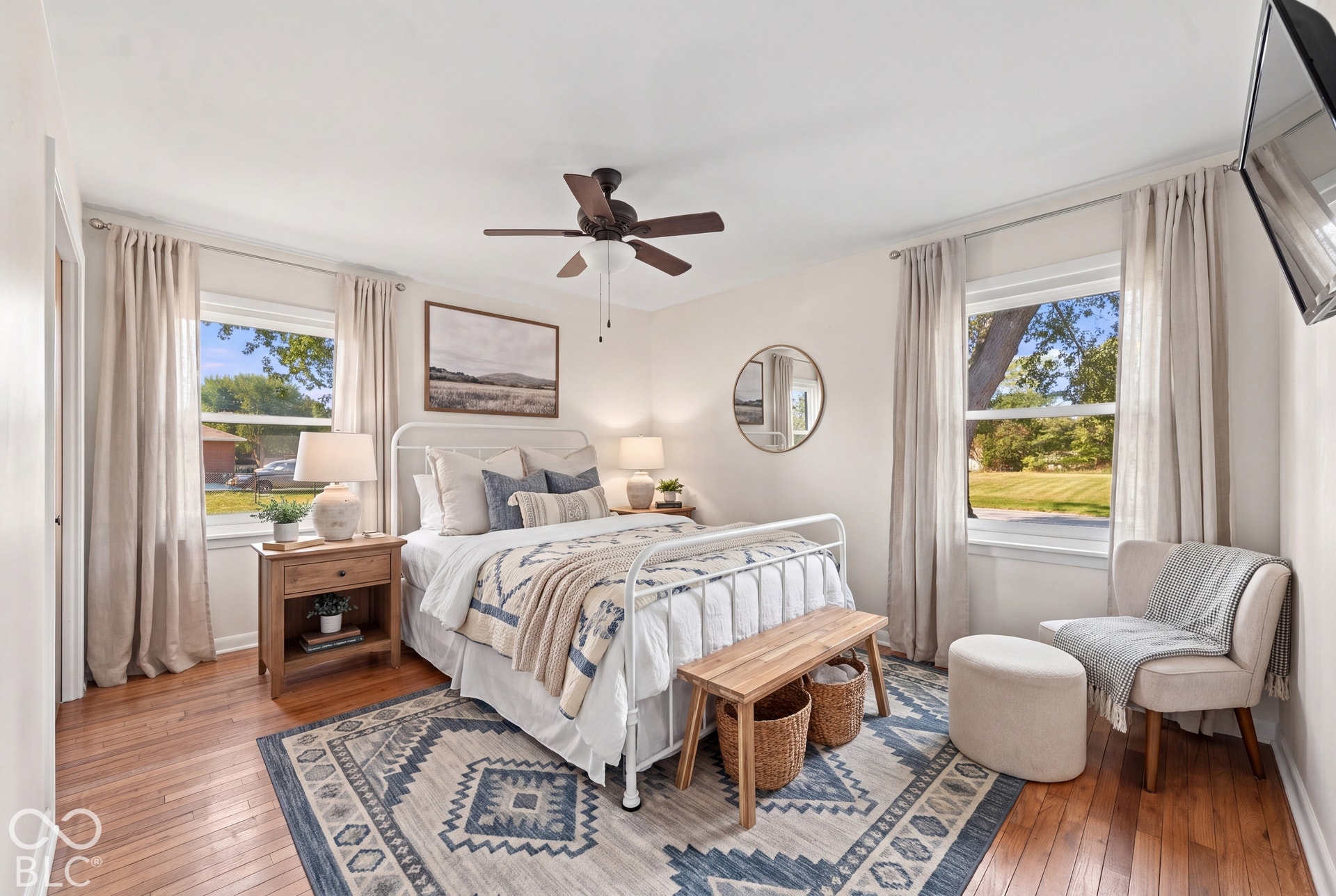 Virtually Altered - Hardwood flooring, painted white walls, white trim, and a ceiling fan with light fixture