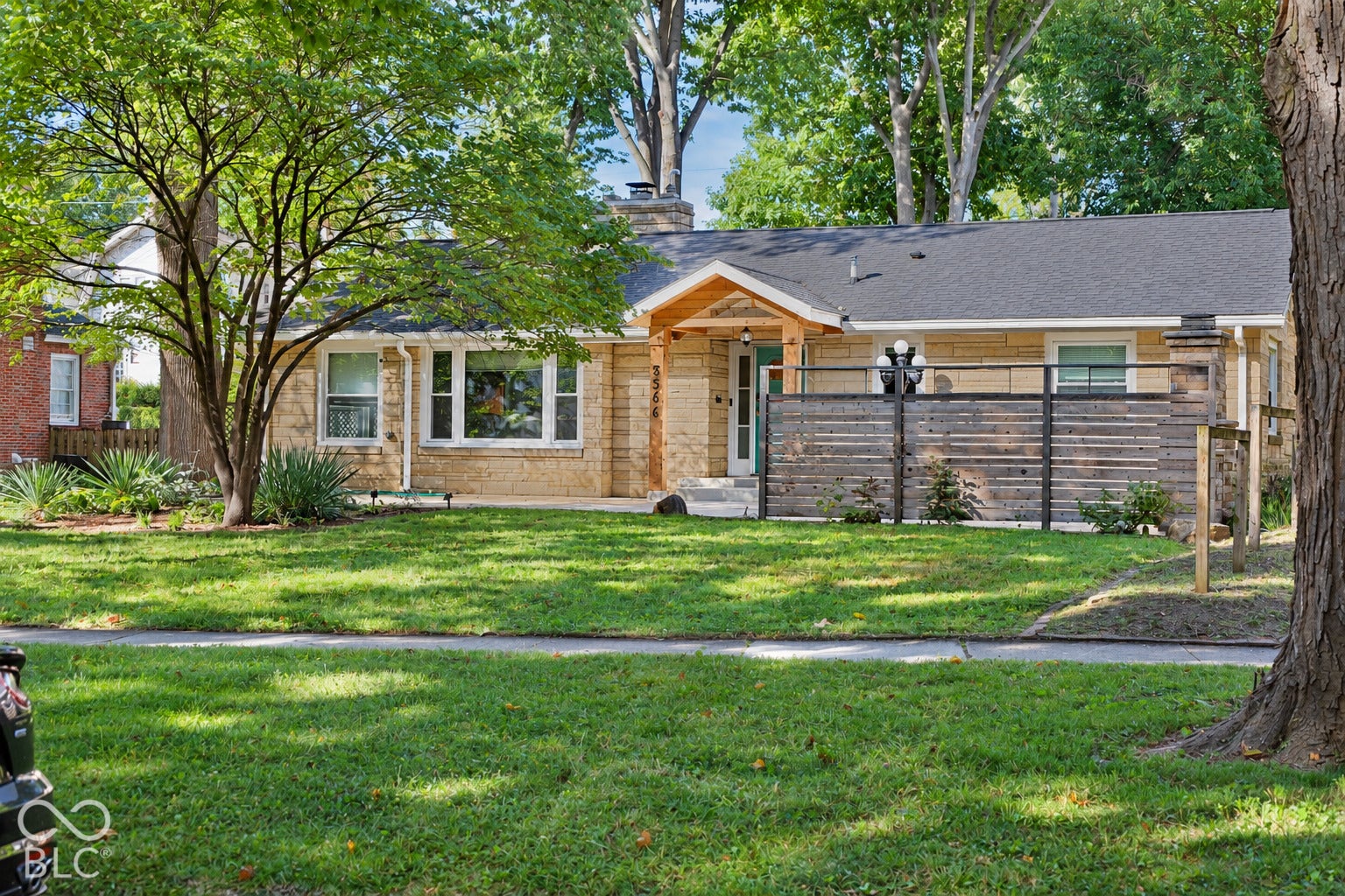 3566 Watson Road, Indianapolis, IN 46205 Single-story residence featuring a brick exterior, a dark shingle roof, and a covered entry with a natural wood-finish ceiling