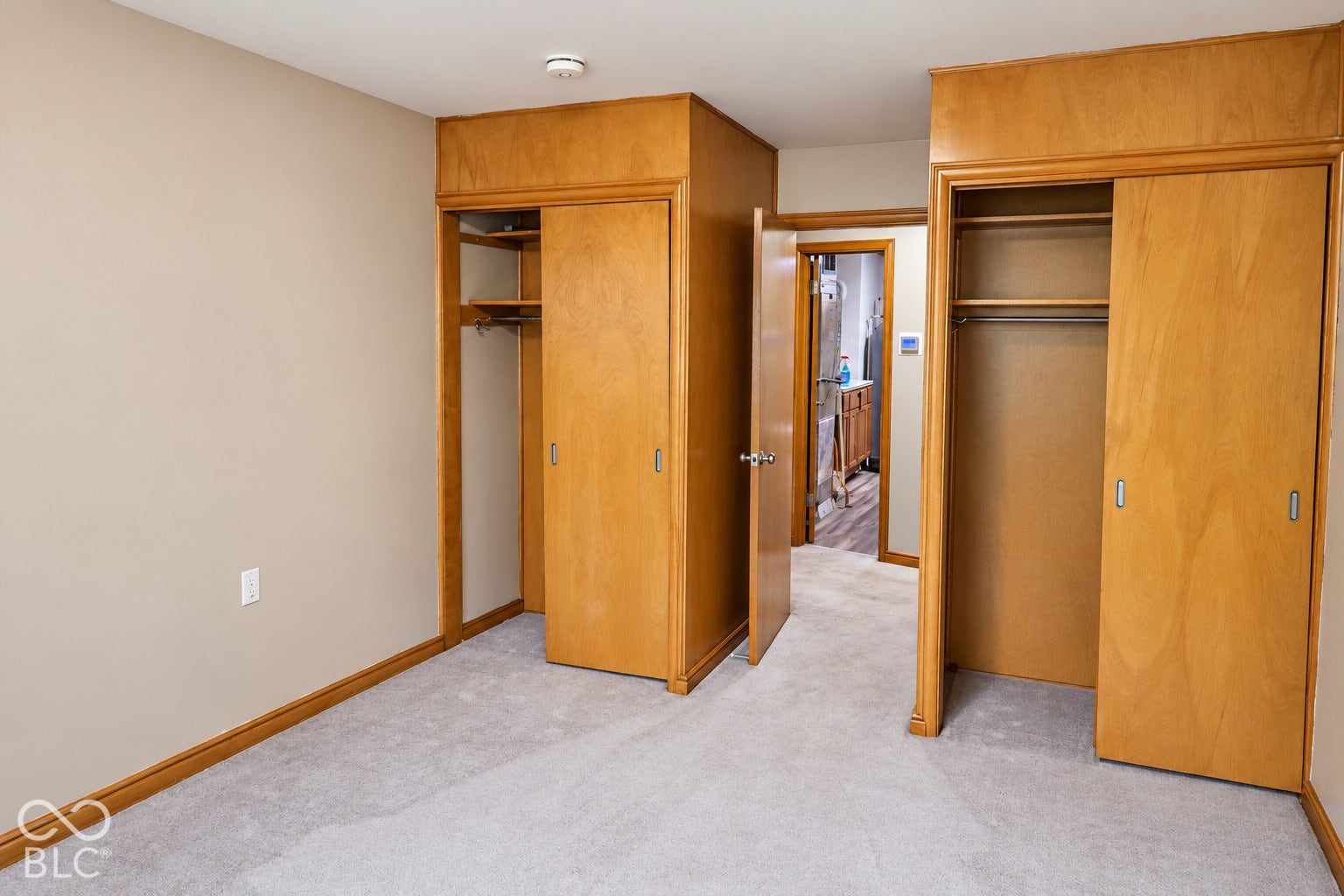 3566 Watson Road, Indianapolis, IN 46205 Carpet flooring throughout, neutral wall paint, two integrated closets with wood-finish doors and shelving, and wood trim accents