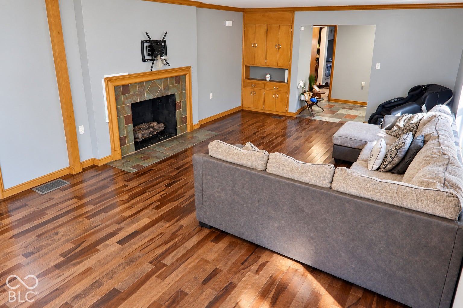 3566 Watson Road, Indianapolis, IN 46205 Hardwood flooring, tiled fireplace with hearth, built-in cabinetry, and wood trim accents