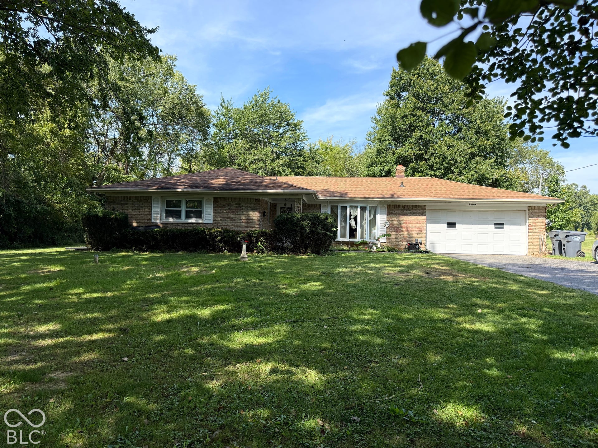 Brick exterior with a light brown shingle roof