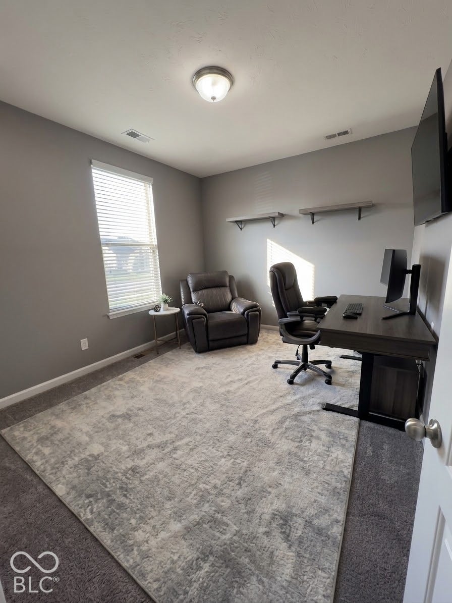 Recessed lighting, wall-mounted shelving, window with blinds, and carpeted flooring