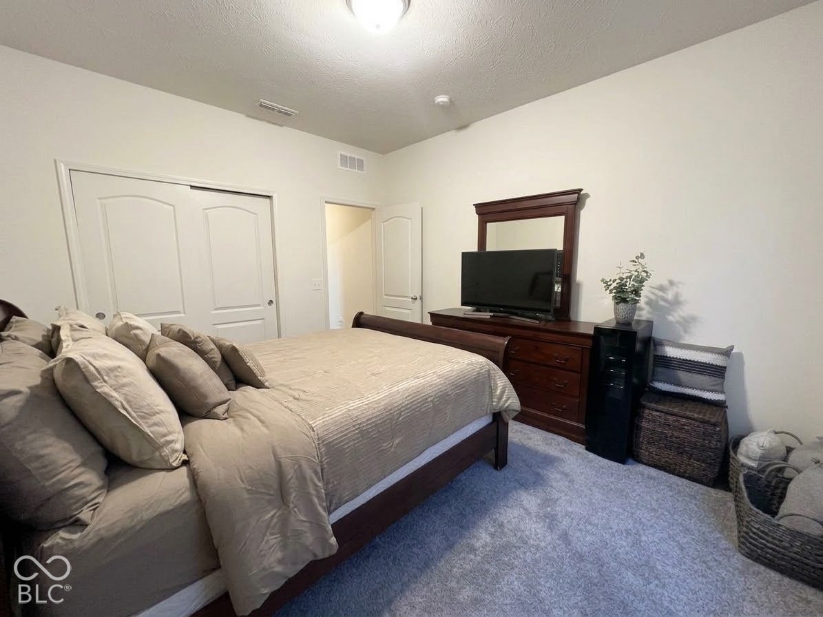 Neutral-toned walls complement the light blue carpeting