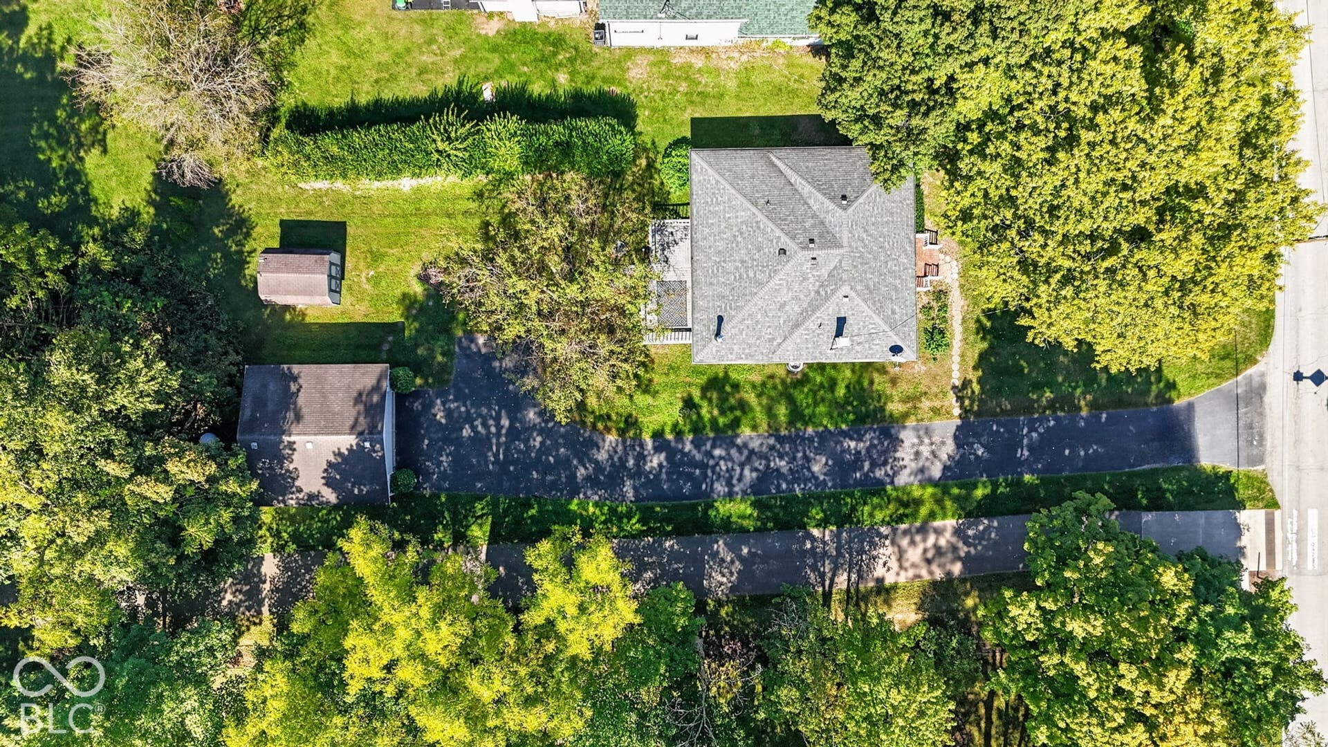 Paved driveway leading to a single-story residence with a multi-gabled roof