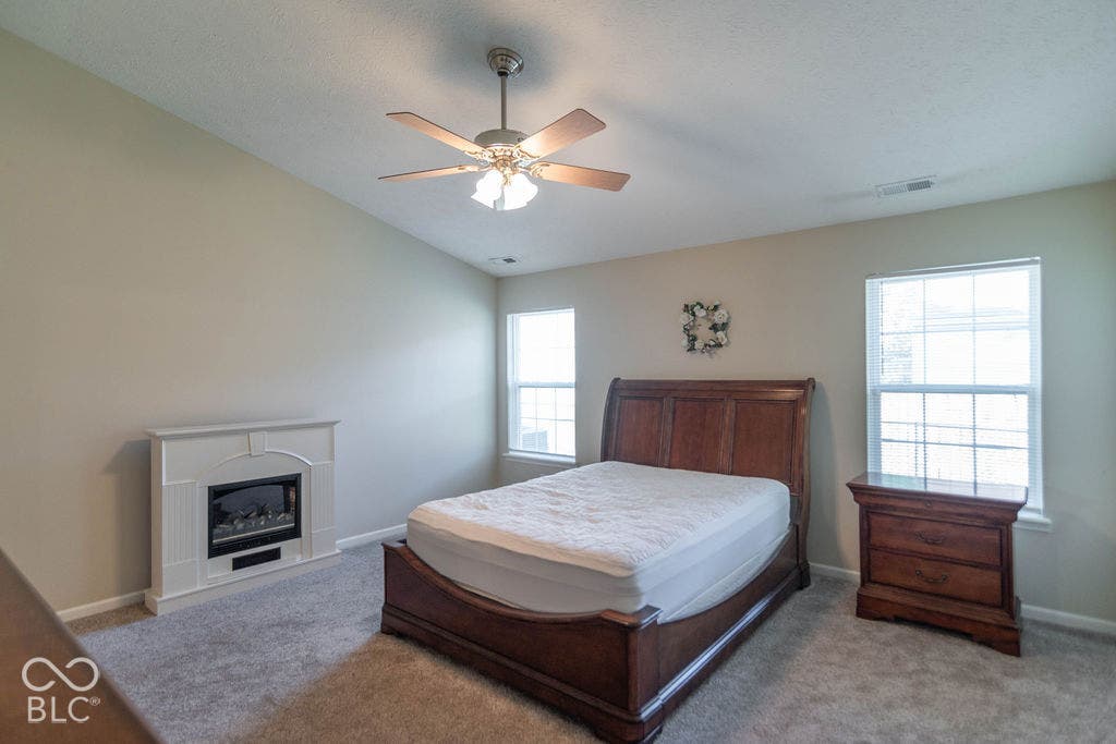 Large primary bedroom with vaulted ceiling.