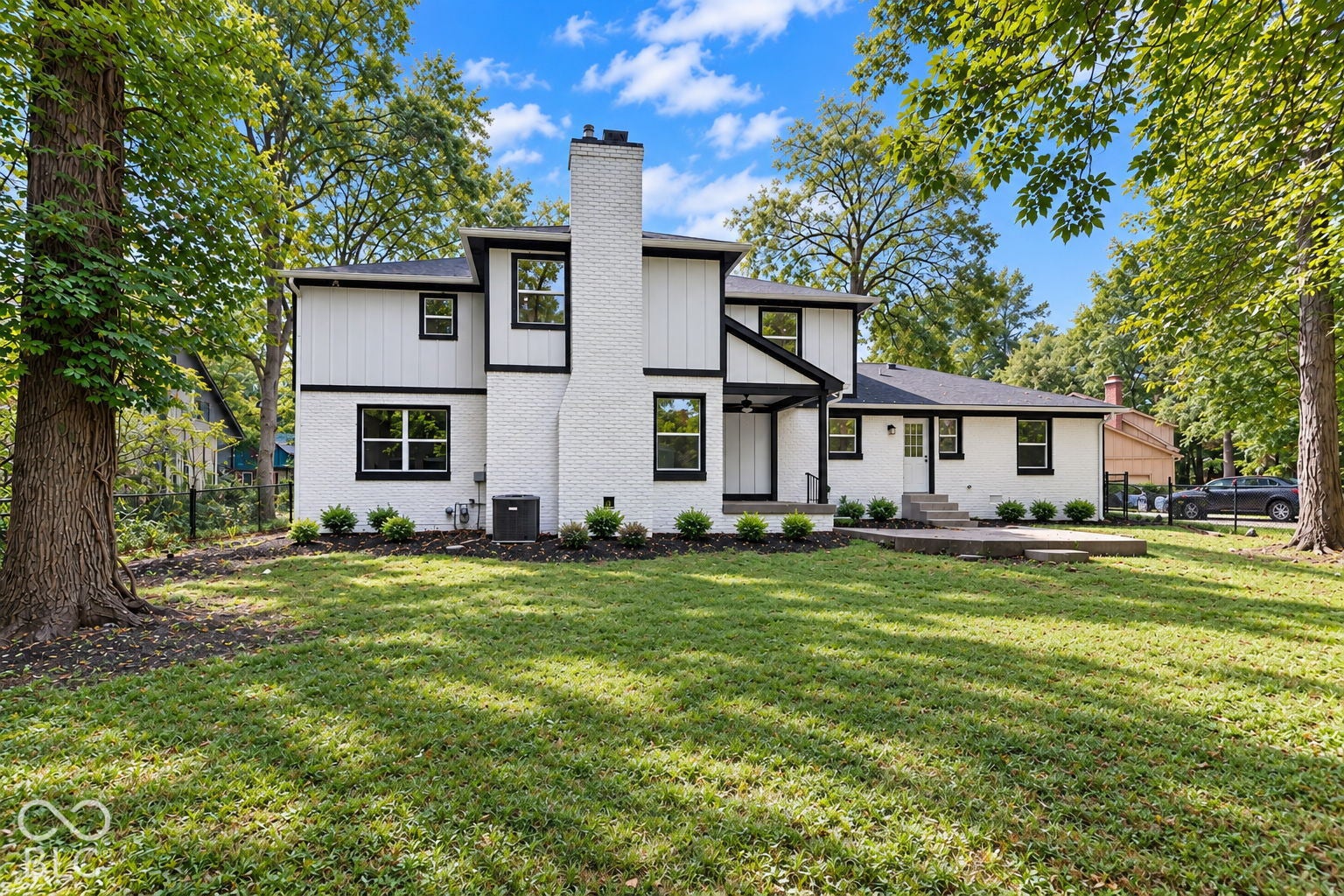 Virtually Altered - White brick and board-and-batten exterior with contrasting dark trim
