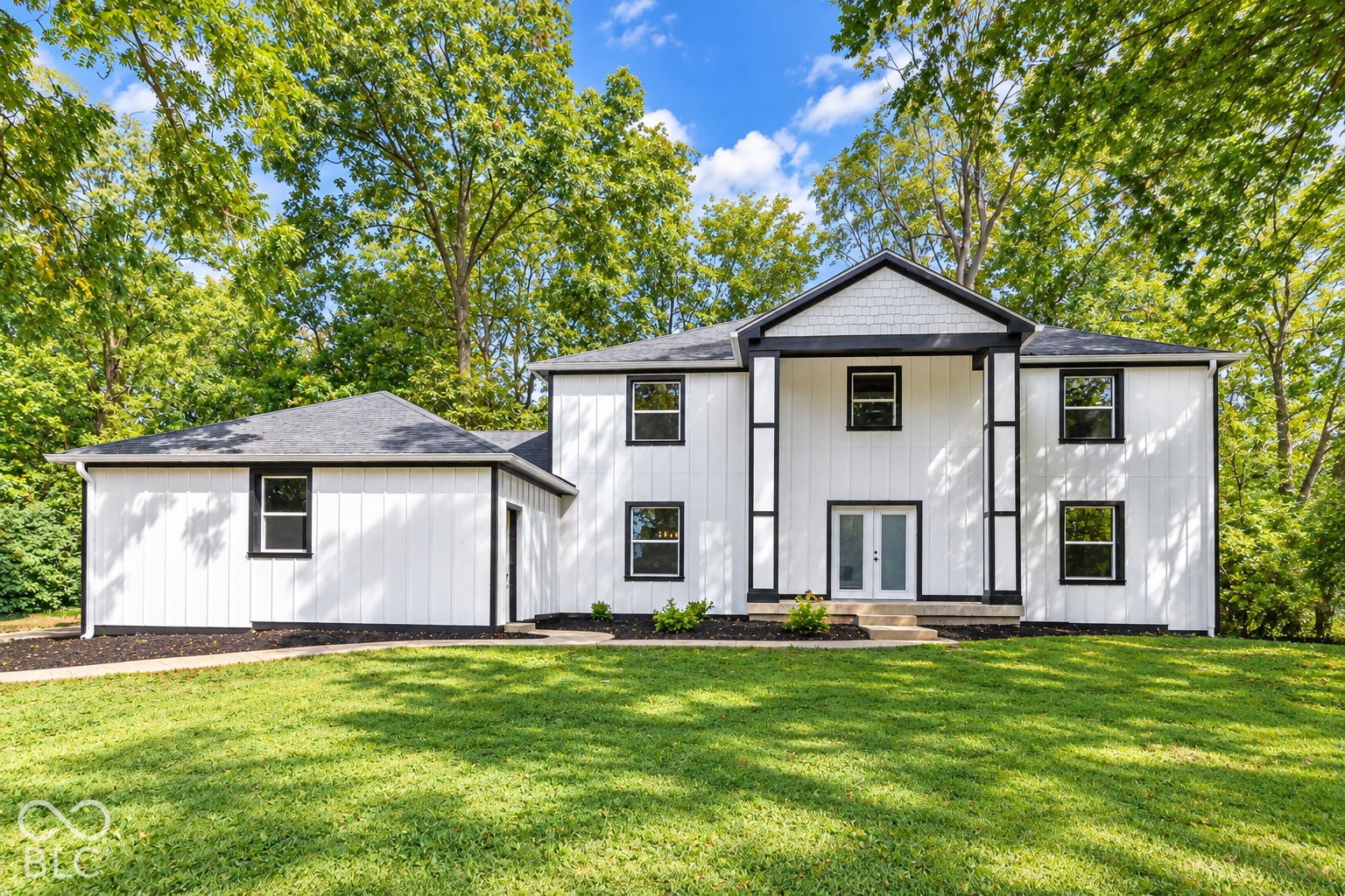 Virtually Altered - White vertical siding exterior with contrasting black trim
