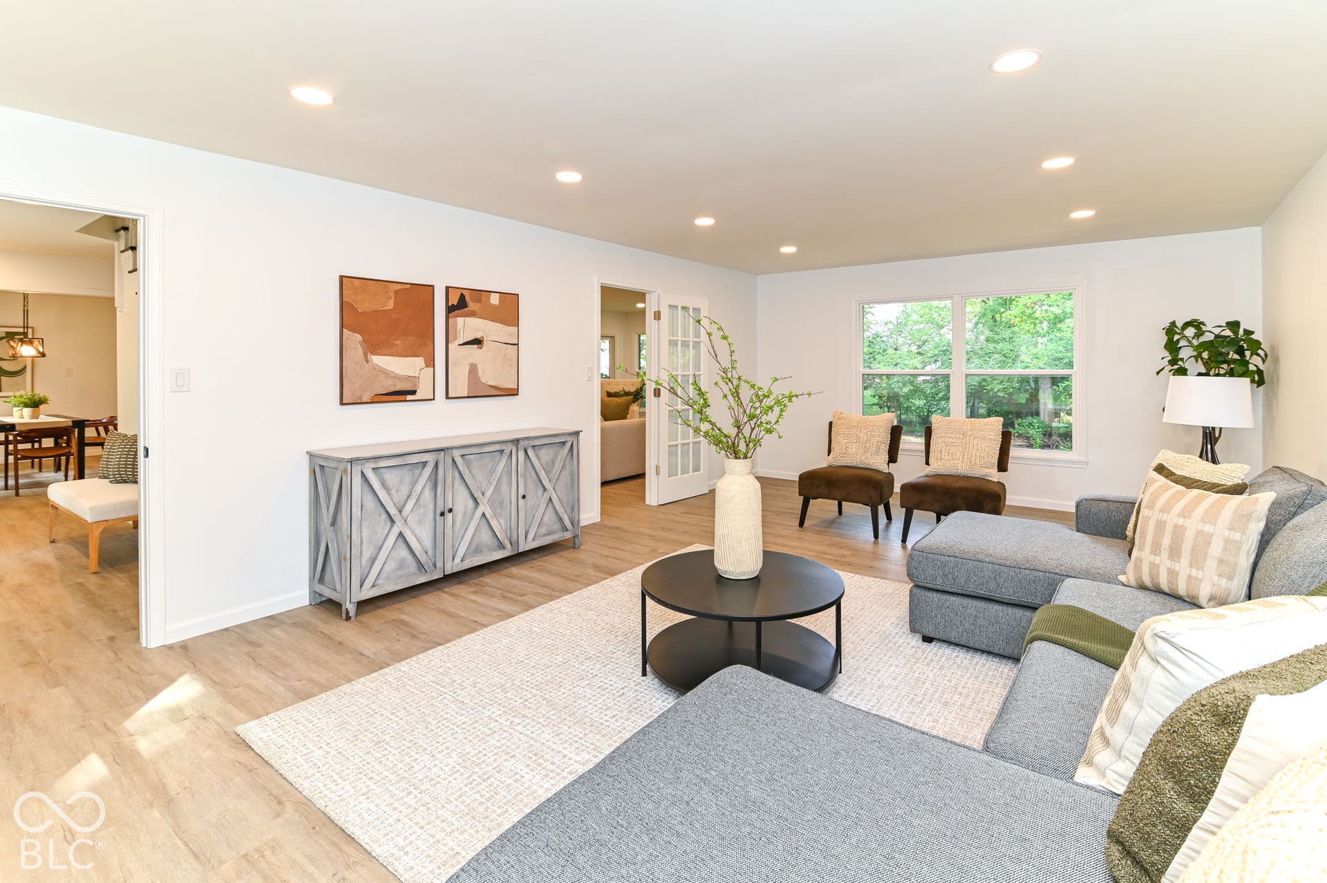 Recessed lighting, wood-finish flooring, and white painted walls