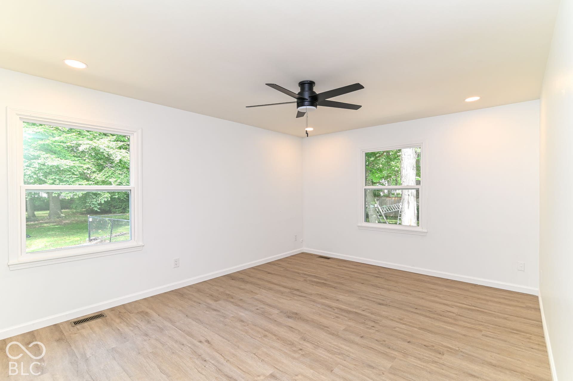 Light wood-finish flooring with white walls