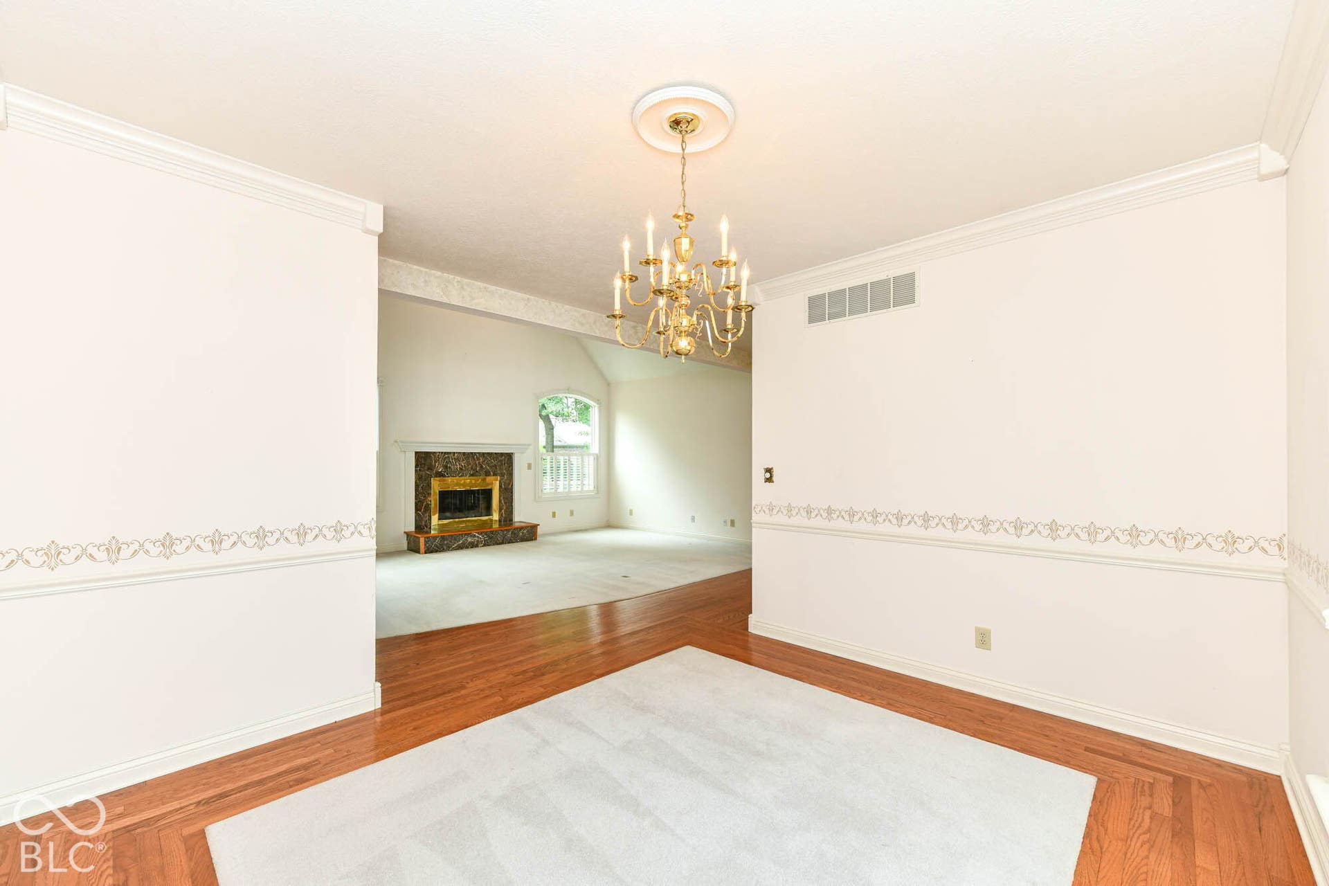 6431 Shamel Drive, Indianapolis, IN 46278 Dining Room. Wood-finish flooring, ornamental chandelier, decorative crown molding