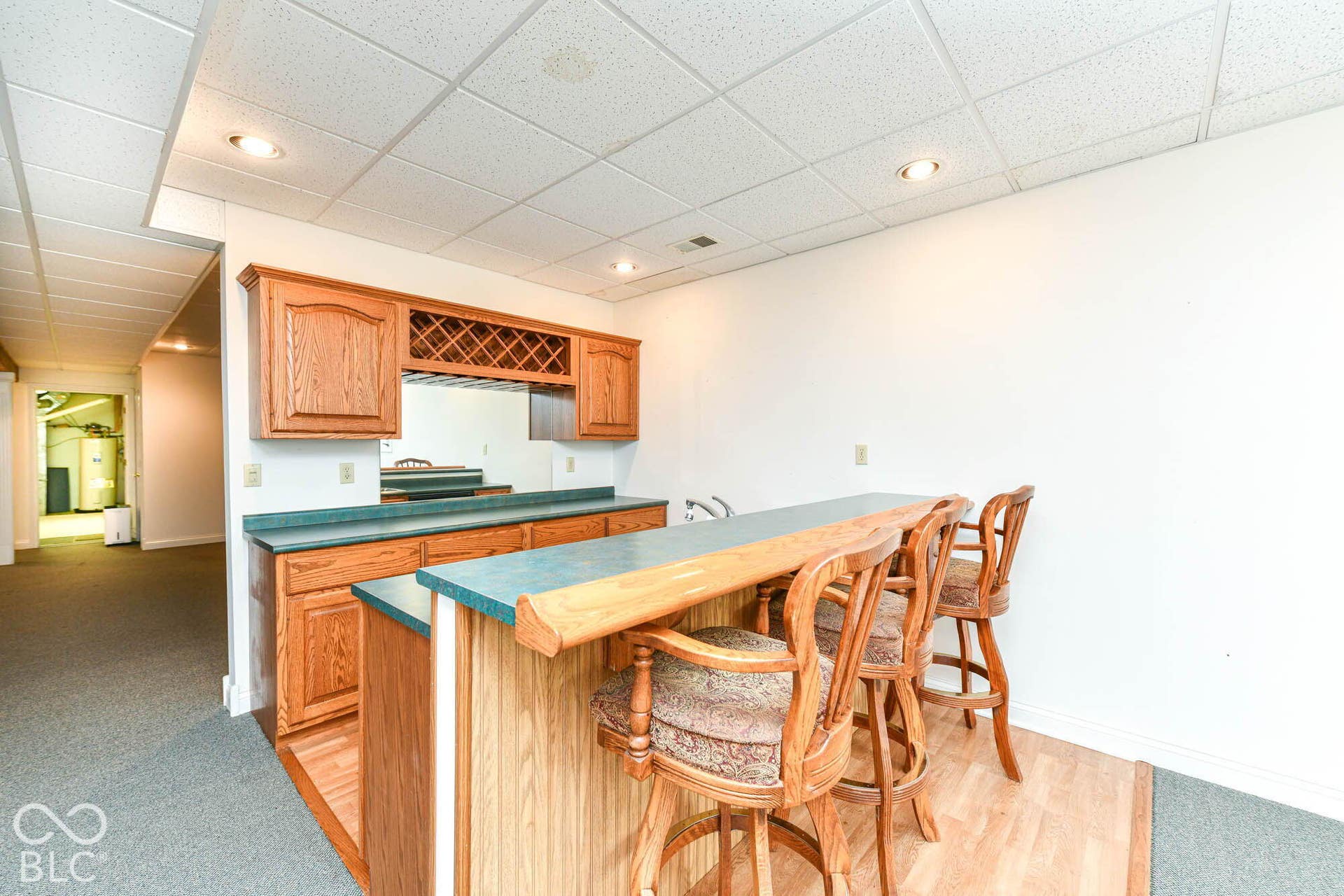 6431 Shamel Drive, Indianapolis, IN 46278 Basement Rec Room. Built-in bar with wood cabinetry, integrated wine rack, sink, and recessed lighting