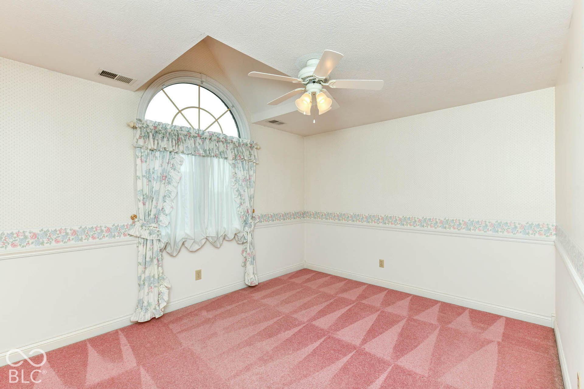 6431 Shamel Drive, Indianapolis, IN 46278 Upper Bedroom. Arch-top window, ceiling fan with integrated lighting, wall-to-wall carpeting and chair rail molding