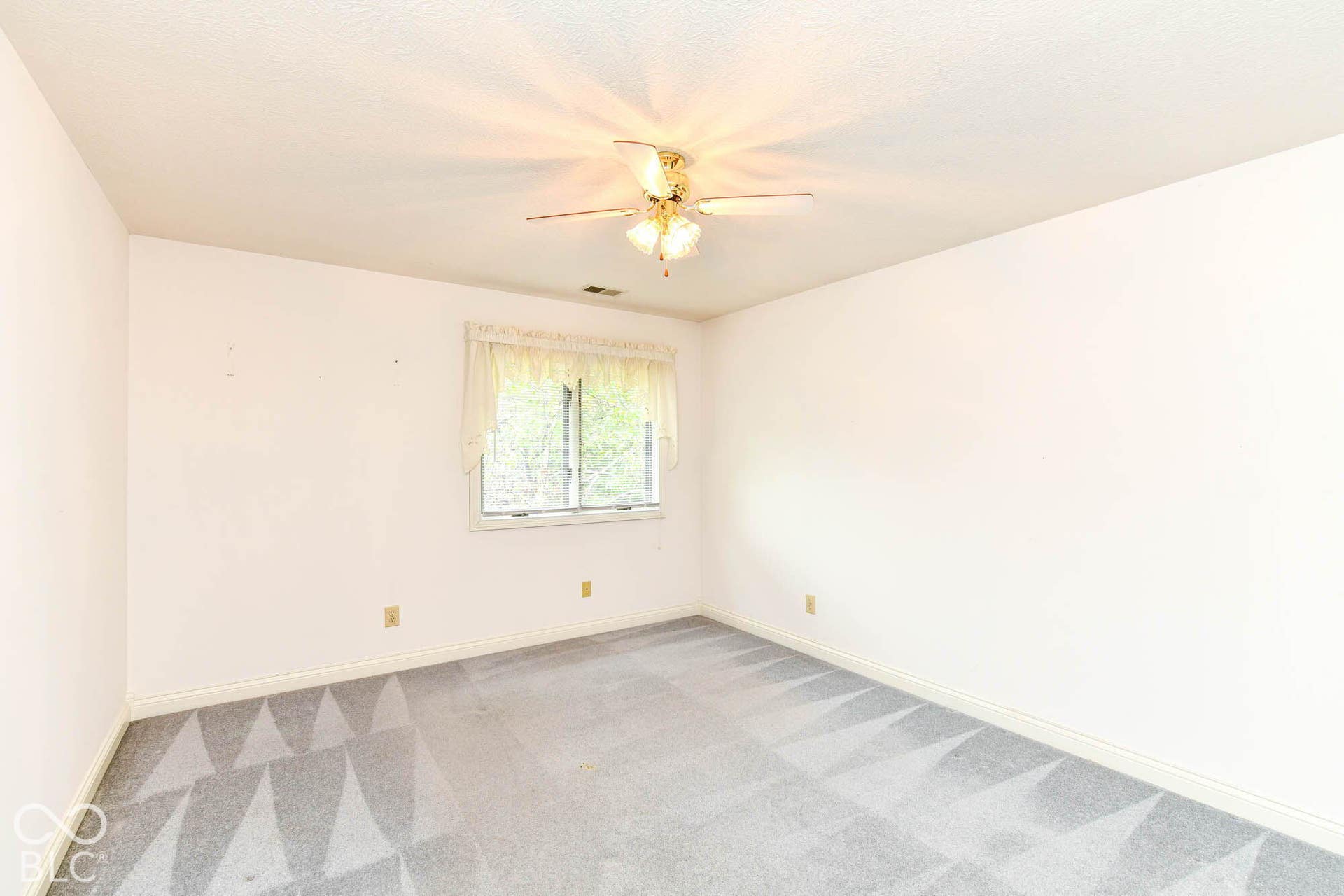 6431 Shamel Drive, Indianapolis, IN 46278 Upper Bedroom. Recessed window with white trim, gold-toned ceiling fan with integrated lighting