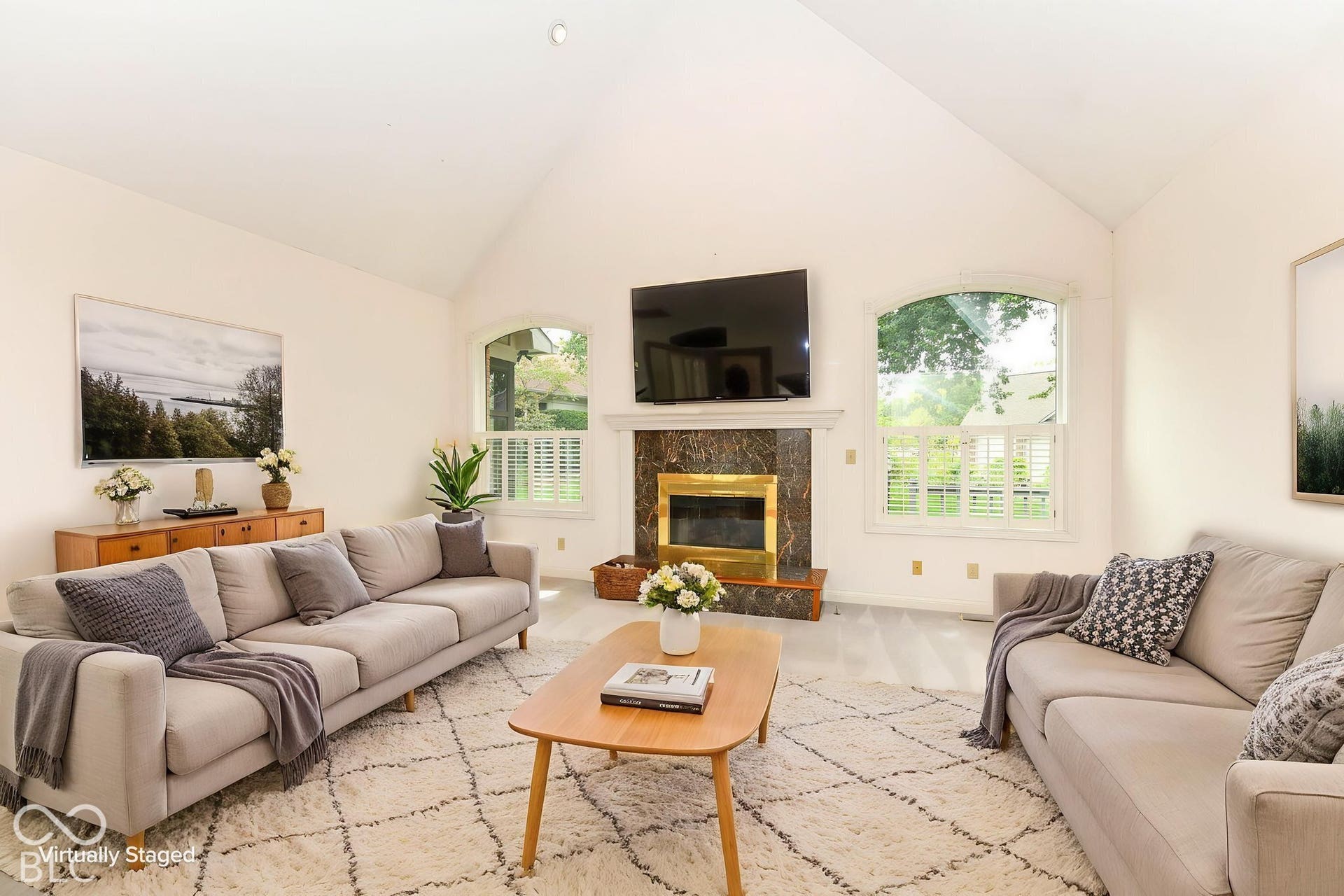 6431 Shamel Drive, Indianapolis, IN 46278 Virtually Altered - Great Room. Vaulted ceiling, arched windows, plantation shutters, fireplace with marble-style surround, brass firebox and wood mantel